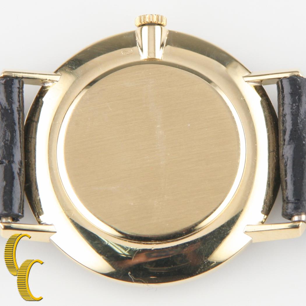 gold watch black leather band