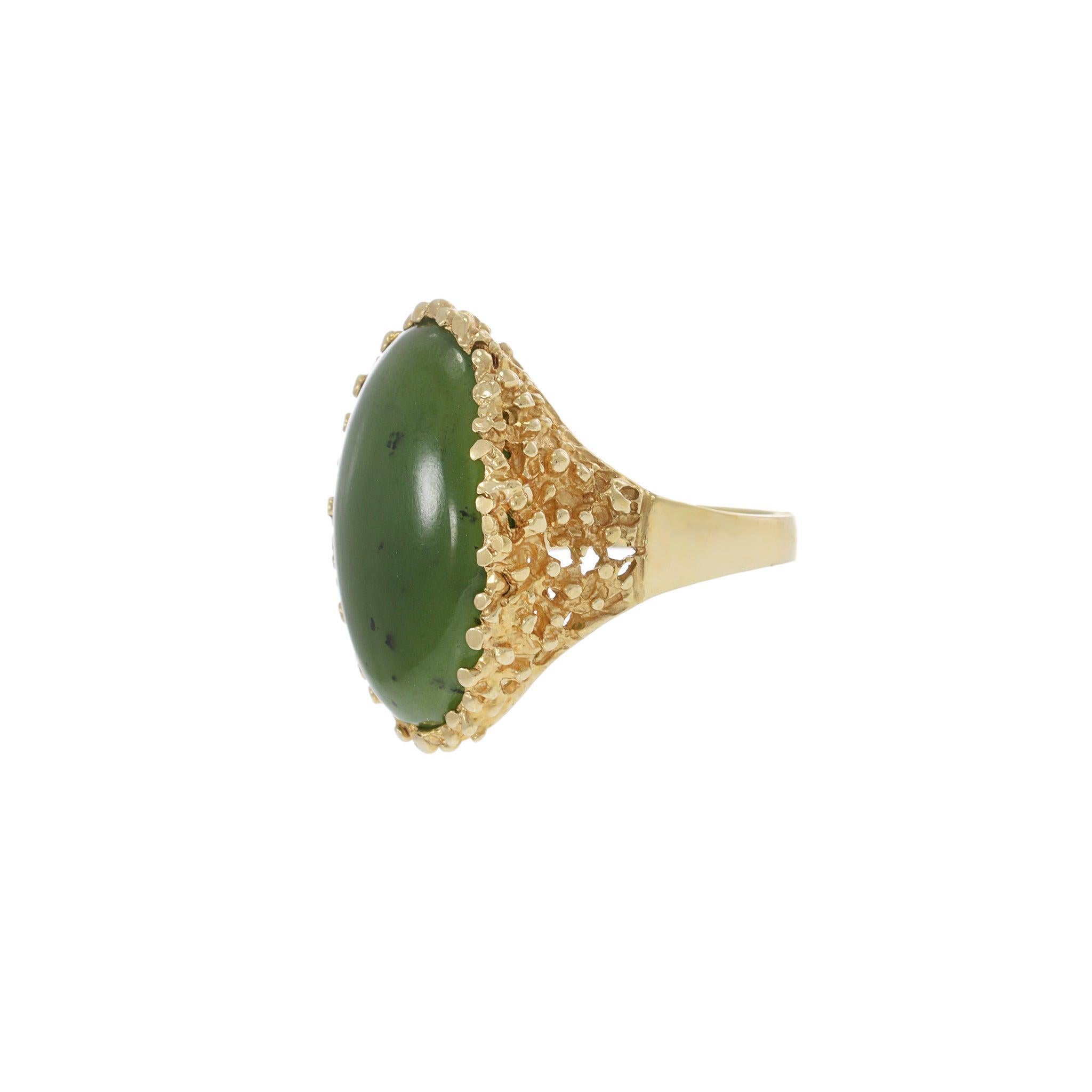 This vintage men’s ring features a richly colored oval jade cabochon, framed by a textured 14KT yellow gold bezel. Bold, earthy, and unmistakably mid-century in style.

Metal: 14KT Yellow Gold
Center Stone: Oval cabochon jade
Design