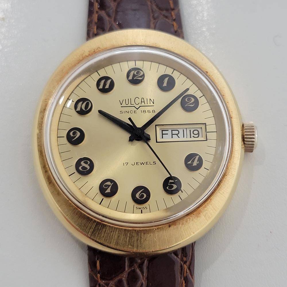 A vintage classic, Men's gold-capped Vulcain day date manual wind dress watch, c.1970s. Verified authentic by a master watchmaker. Gorgeous, Vulcain signed gold dial, applied Arabic numeral hour markers, black minute and hour hands, sweeping central