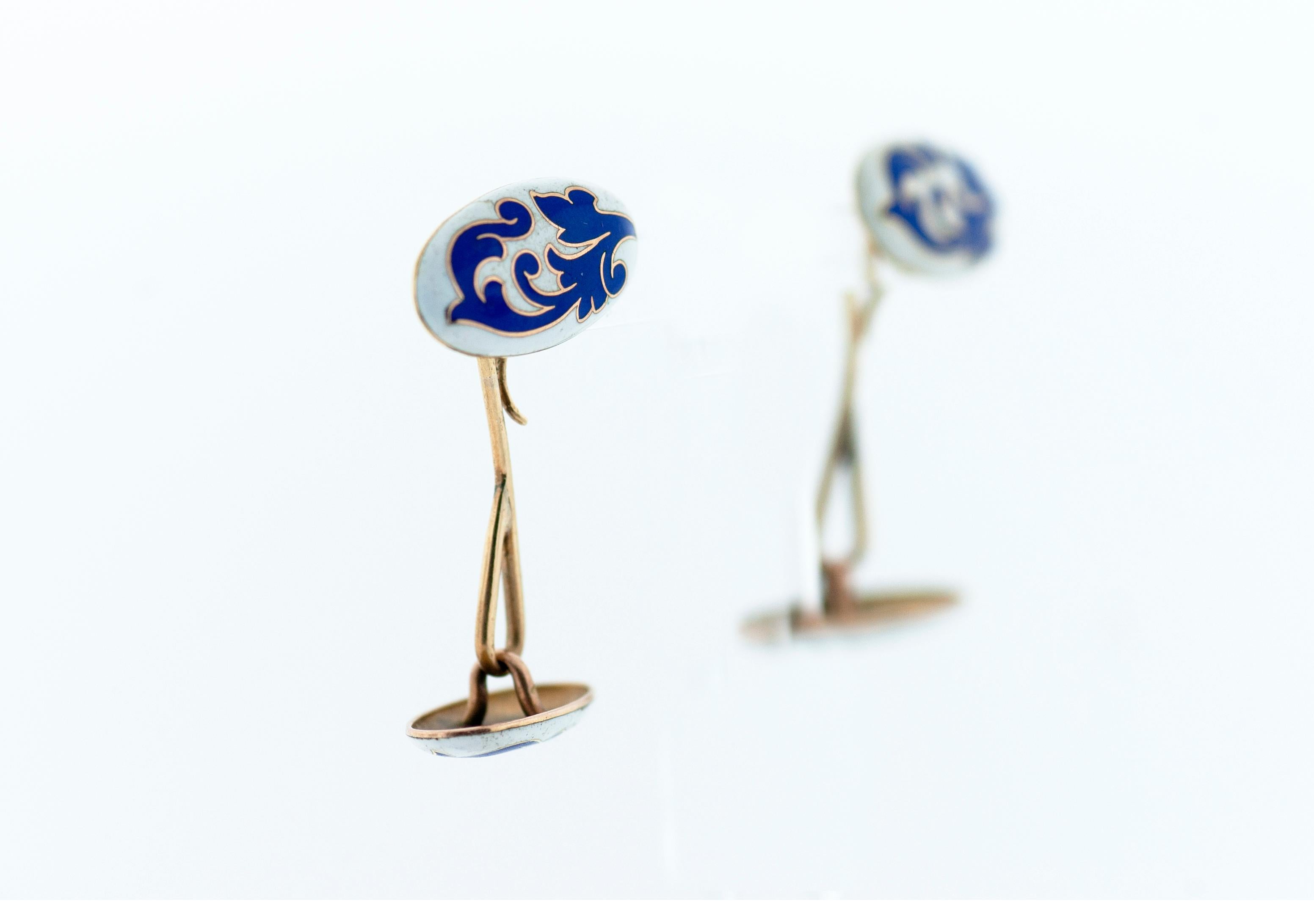 These classic cuff links are dated to the 1920's.  The cuff links are made from white and blue enamel with gold inlay.  The cuff links are linked together and soldered in a classic fashion.  The craftsmanship of the enamel is nothing short of