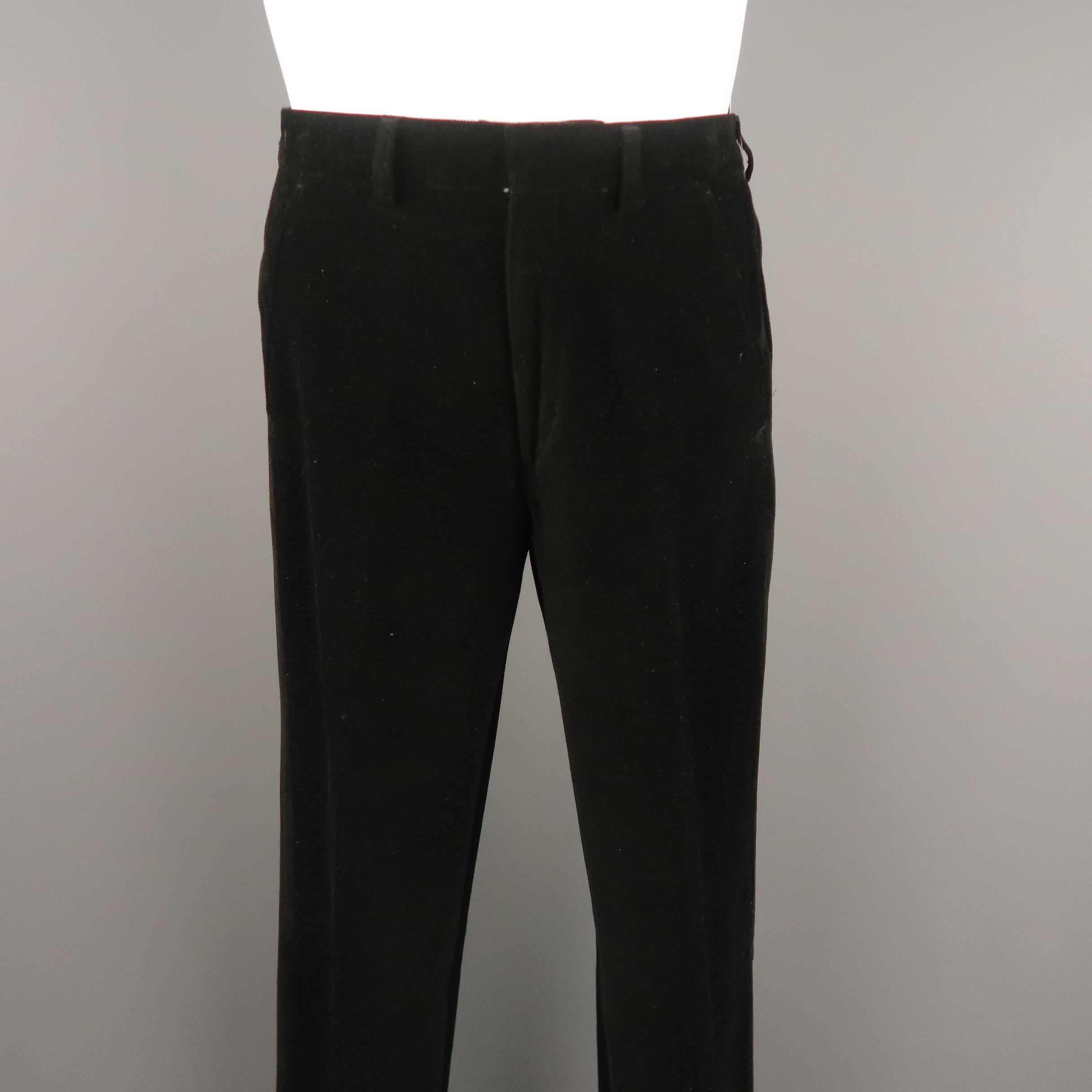 Vintage WILKES BASHFORD pants come in black micro corduroy with a hidden closure waistband and welt pocket. Unhemmed. Made in France.
 
Excellent Pre-Owned Condition.
Marked: 30
 
Measurements:
 
Waist: 31 in.
Rise: 10.5 in.
Inseam:  39 in.