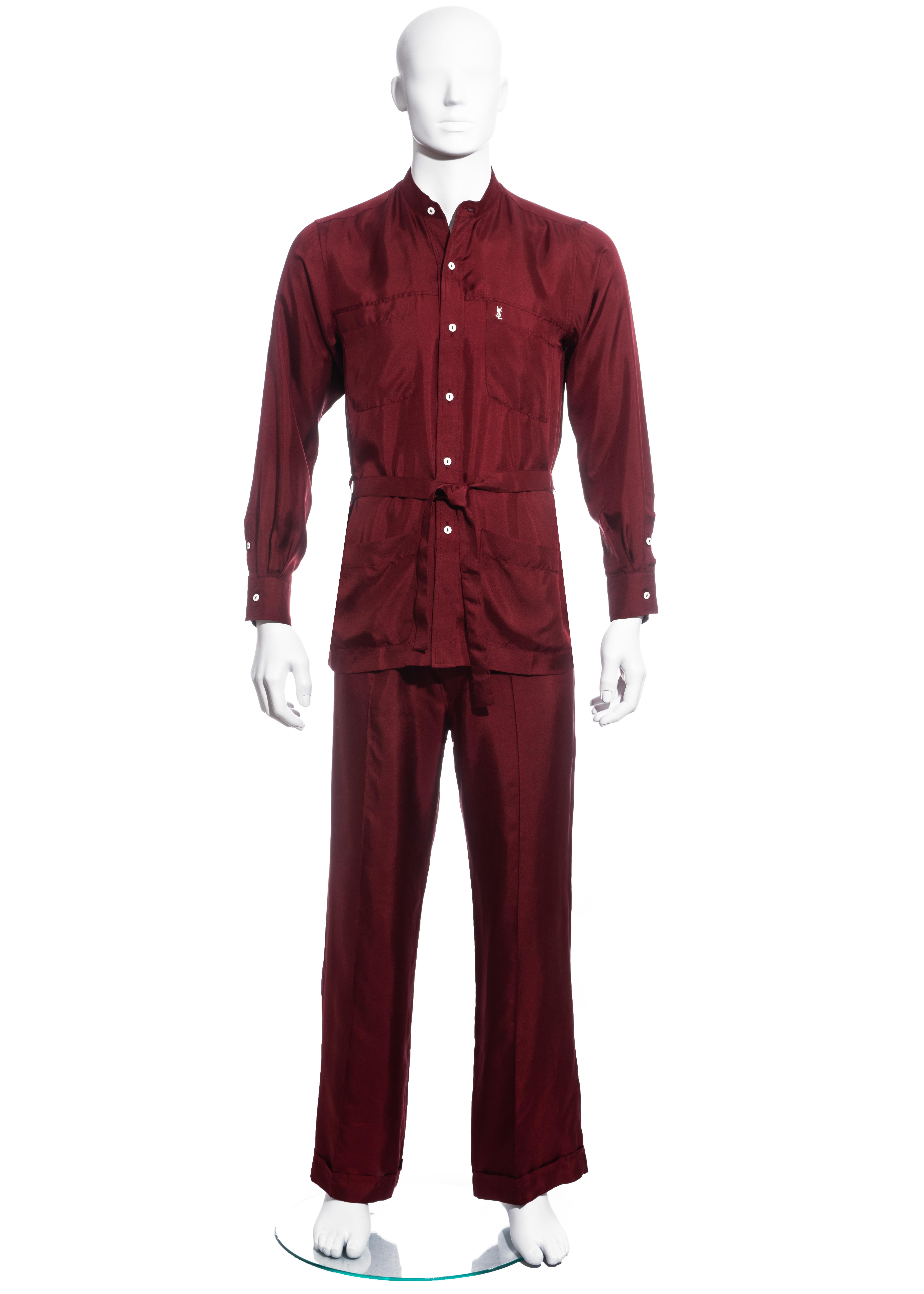 ▪ Men's Yves Saint Laurent red leisure suit
▪ 100% Silk 
▪ Mandarin collar
▪ Embroidered YSL logo on chest
▪ Tie-up waist belt 
▪ Cuffed drawstring pants 
▪ Size Small
▪ Spring-Summer 1978