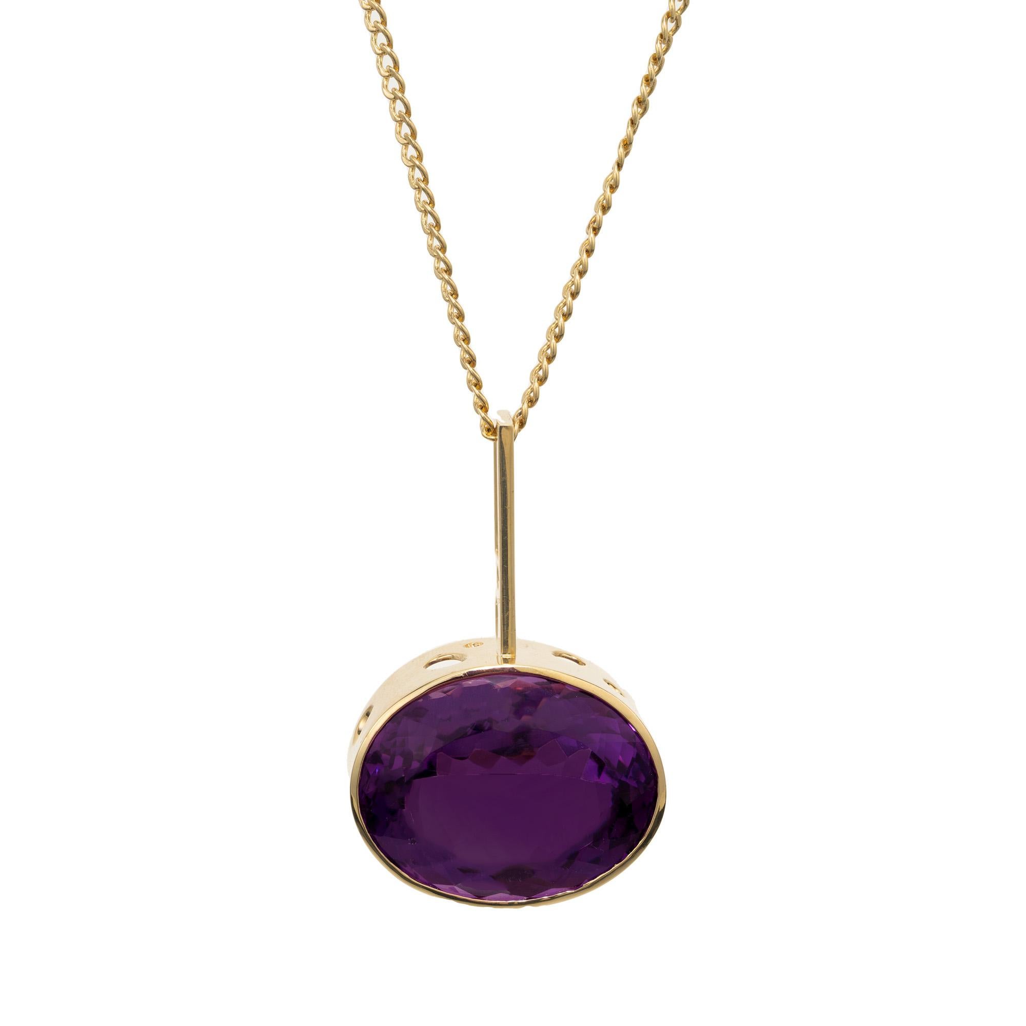 The Mento 1970's 57.47ct Amethyst yellow gold pendant necklace is exquisite in its beauty and elegance. Like a droplet of regal purple suspended in luminous golden sunlight, the oval amethyst at the heart of this necklace captures attention with its