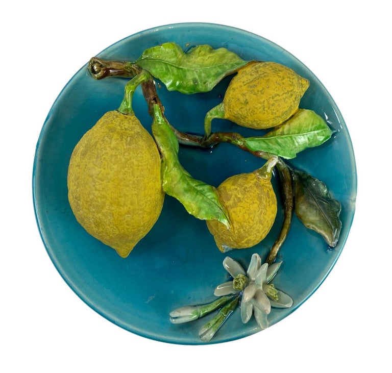 Menton French Majolica Barbotine wall plaque on a turquoise ground with lemons molded in high relief, circa 1880, with incised mark for Joseph Saissi, measures: diameter 8 inches.
Generally referred to as 