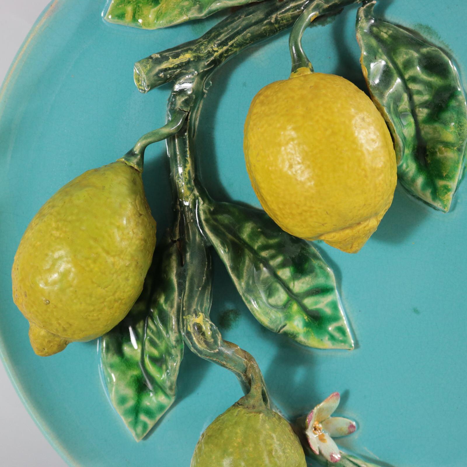 Menton French Majolica wall plate which features lemons, leaves and flowers. Colouration: turquoise, green, yellow, are predominant.