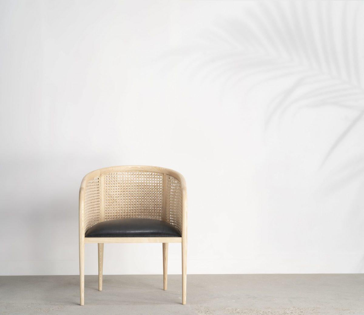 Inspired by a traditional cane chair design, this chair is a contemporary version of a much loved classic that we have seen in many forms. The spoke-shaved frame is a solid ash, given smooth edges accentuated by the rich black polish or gentle