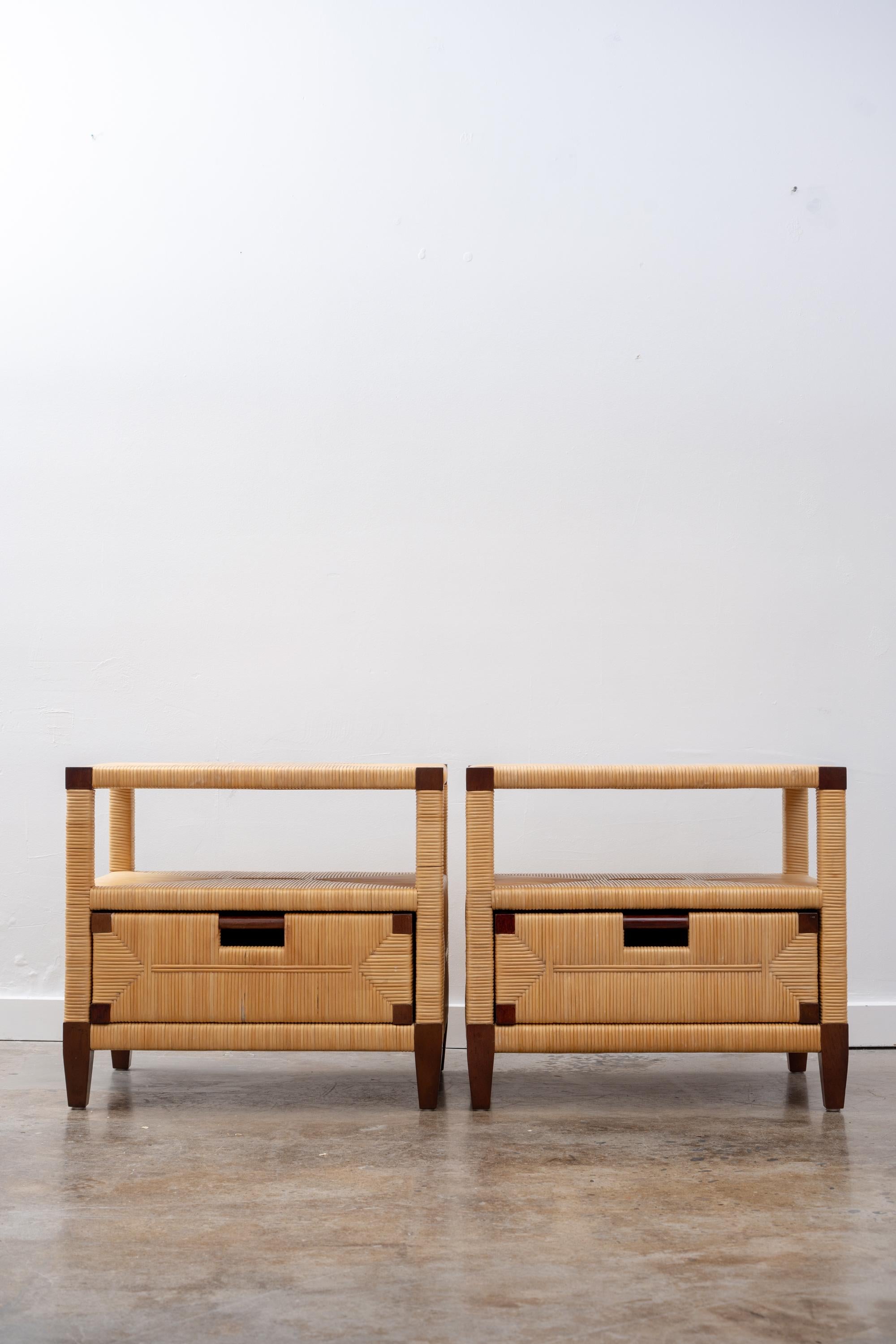 Exceptional pair of scarce tables by John Hutton. As principal designer for Donghia, these are from his 1995 collection “Merbau” and were produced in very low numbers. 
With rich mahogany frames and beautifully woven cane throughout, each has one