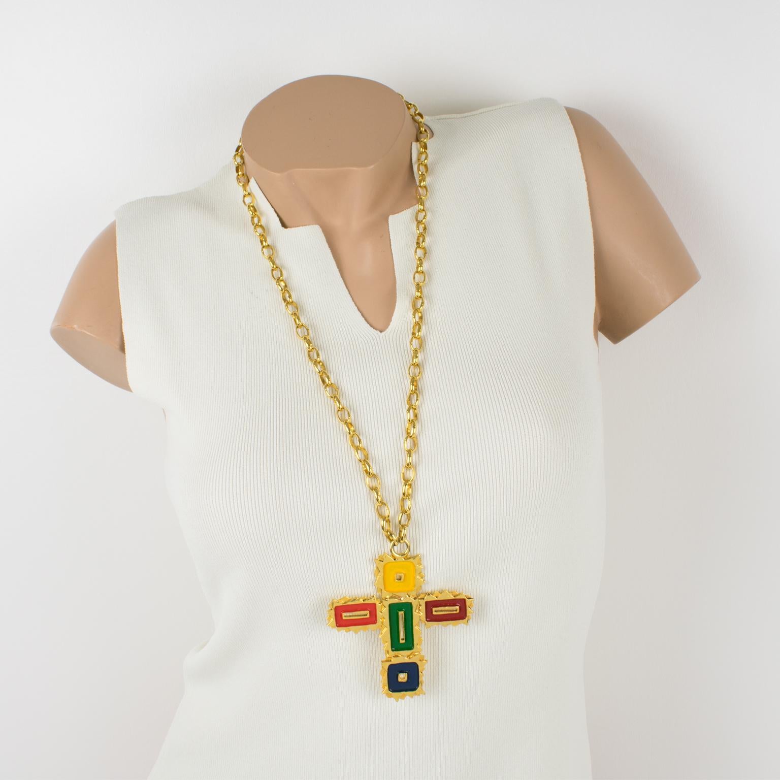 This gorgeous Mercedes Robirosa Paris couture pendant necklace features an oversized gilt metal all-textured and pierced cross pendant ornate with enamel in red, green, blue, and yellow colors. The heavy gilded metal chain has a hook closing clasp