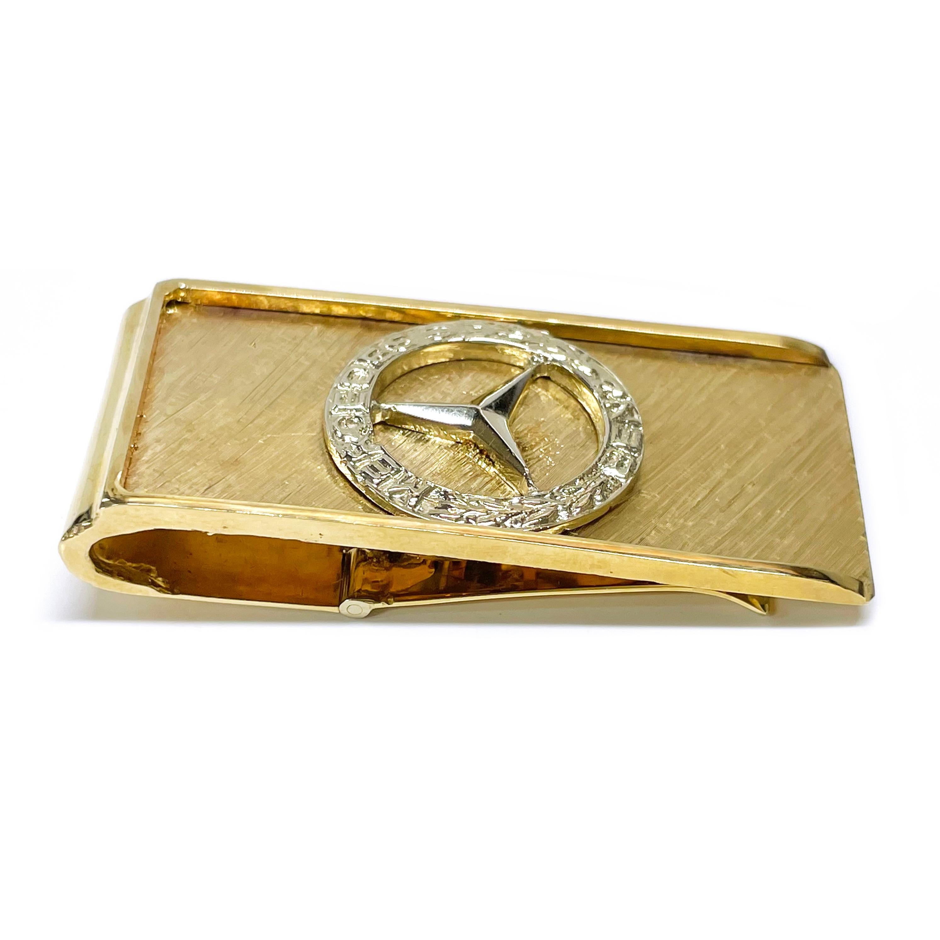Mercedes 18 Karat Yellow Gold Hinged Money Clip. Handcrafted hinged money clip with custom made tubular roller, money won't be torn. The top of the tie clip has a satin brushed texture with raised bezel and Mercedes Benz logo with name. The