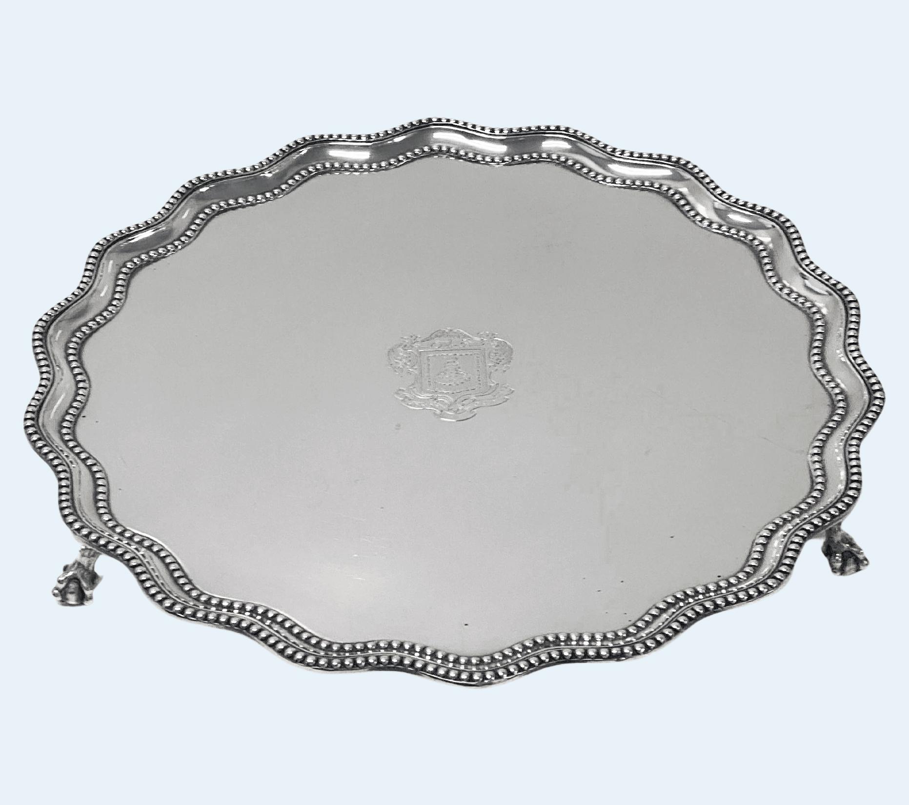 Mercers Company Garrard Antique Silver large Salver by James Garrard, London 1897.
Shaped circular form with a raised beaded wavy-edge rim, raised on three claw and ball feet, the underside engraved 
