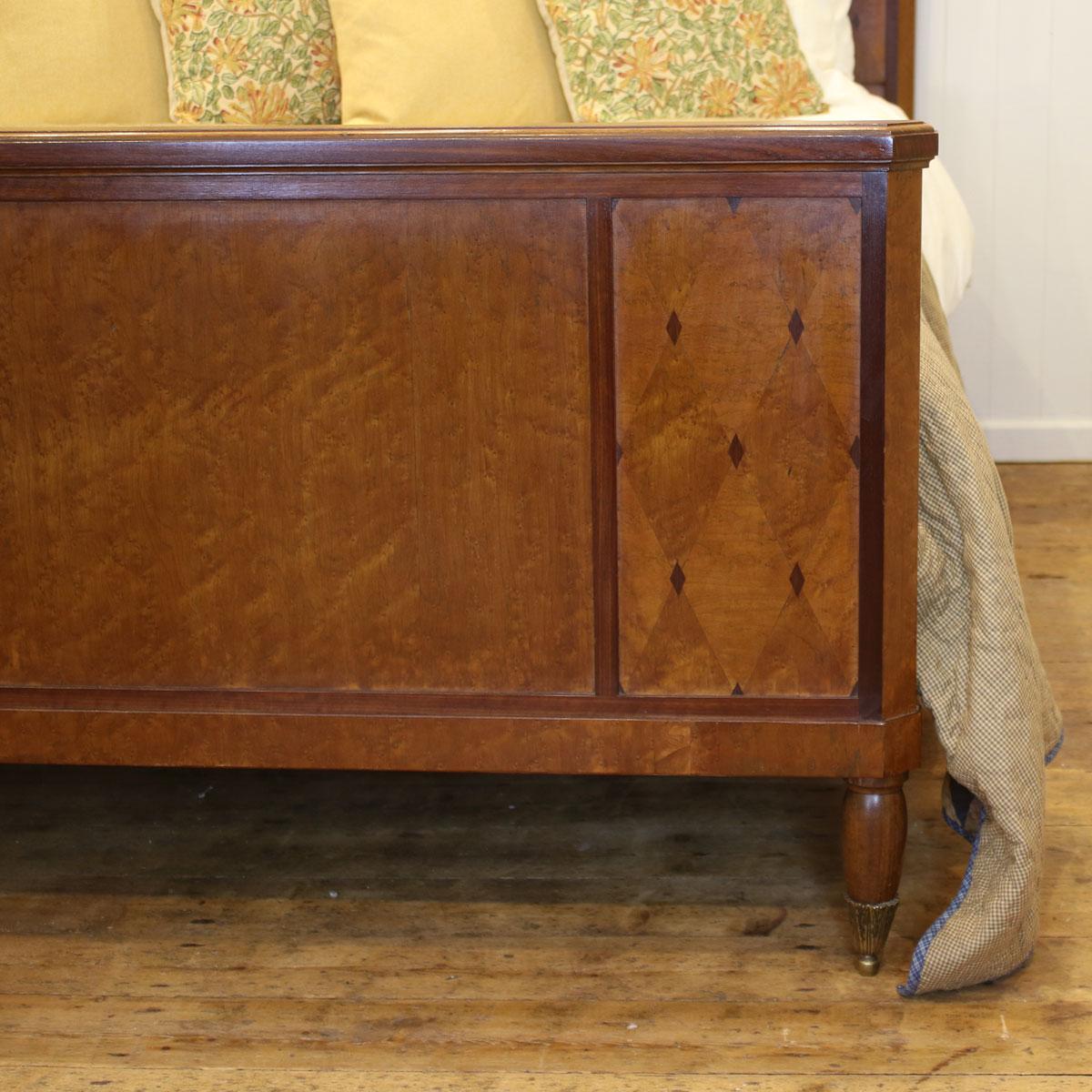 A two-piece antique bedroom set manufactured by Mercier Frères of Paris, consisting of a mahogany inlaid antique bed and beautiful matching wardrobe.

The bed has a mahogany frame with a burr walnut veneer. The headboard has an intricate arch of