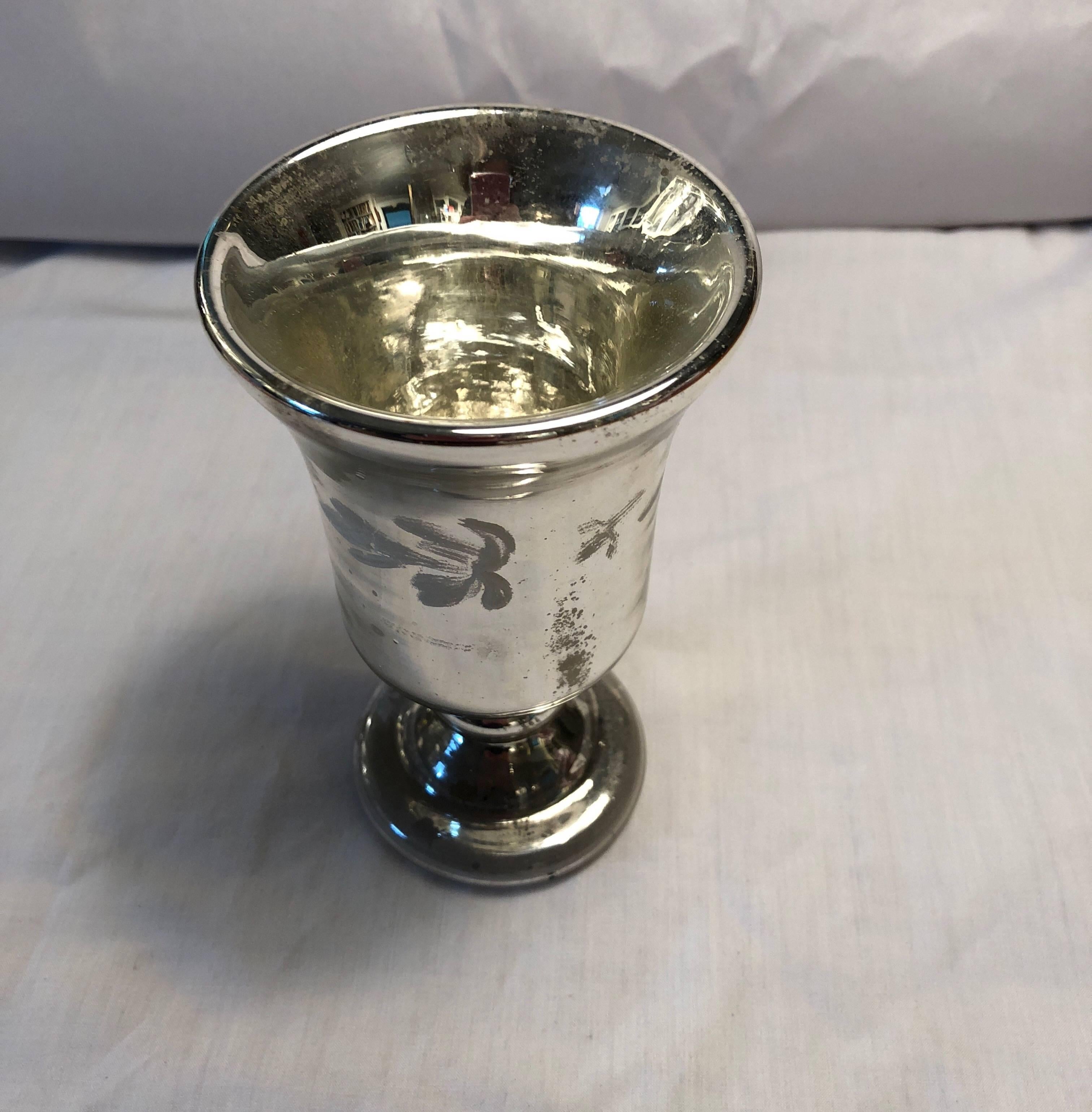 Mercury glass footed cup or small vase with raised white decoration.
