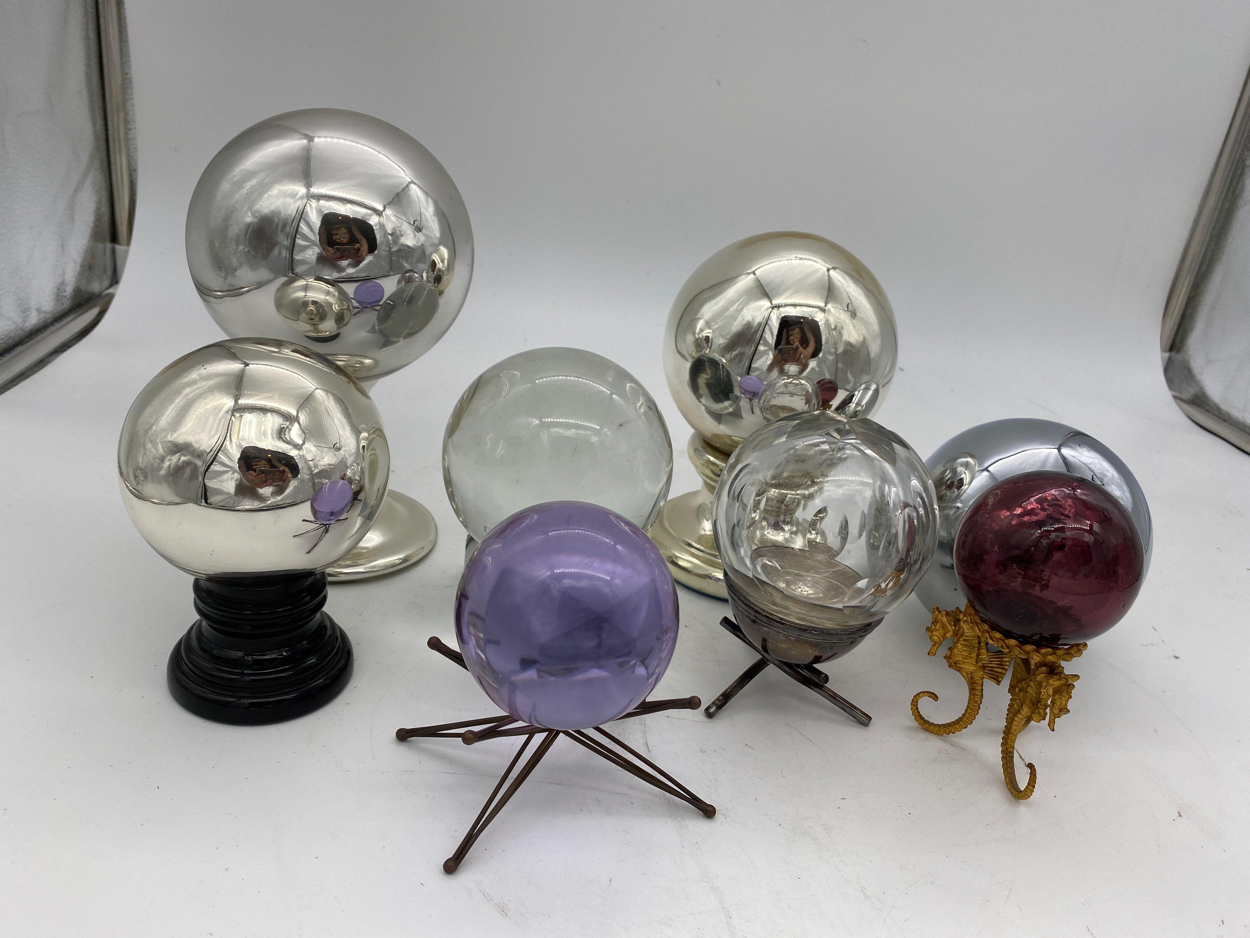 Collection of 7 spheres featuring 2 in mercury glass and 5 glass. Six come with bases.

The largest is 3