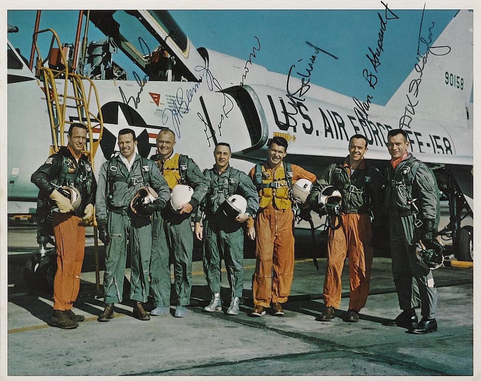 This collage features a NASA official color lithograph for Mercury 7 with autographs of six of the crew members: Gordon Cooper, J.H. Glenn Jr., Gus Grissom, W.M. Schirra Jr., Deke Slayton, and a secretarial signature of Alan B. Shepard. Just above