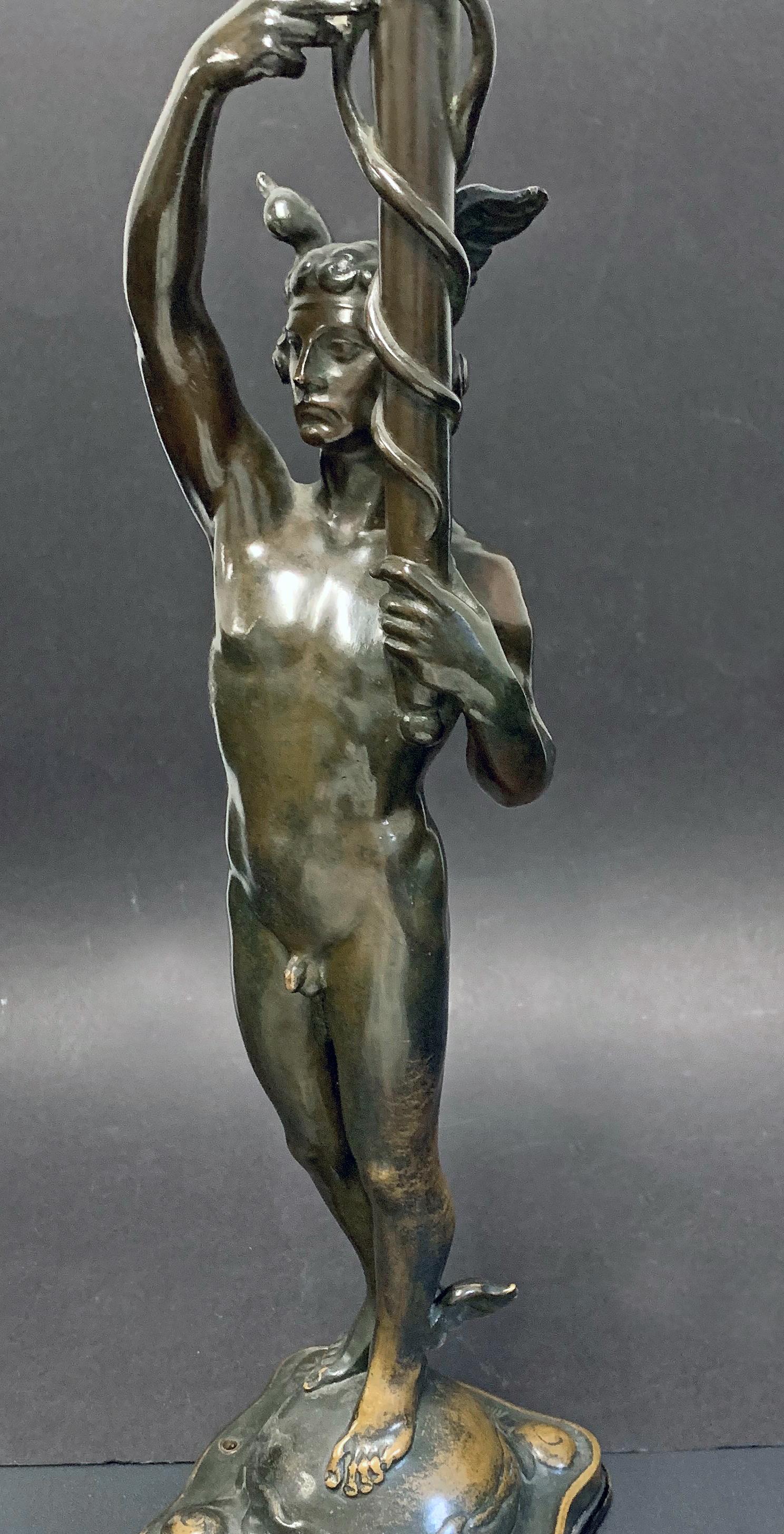 A large and impressive bronze depicting the nude god Mercury holding a large caduceus aloft, this piece was sculpted by Alfred Ohlson, a Swedish sculptor who was known for his sensuous figural bronzes in the 1910s and 1920s. Here he shows Mercury as