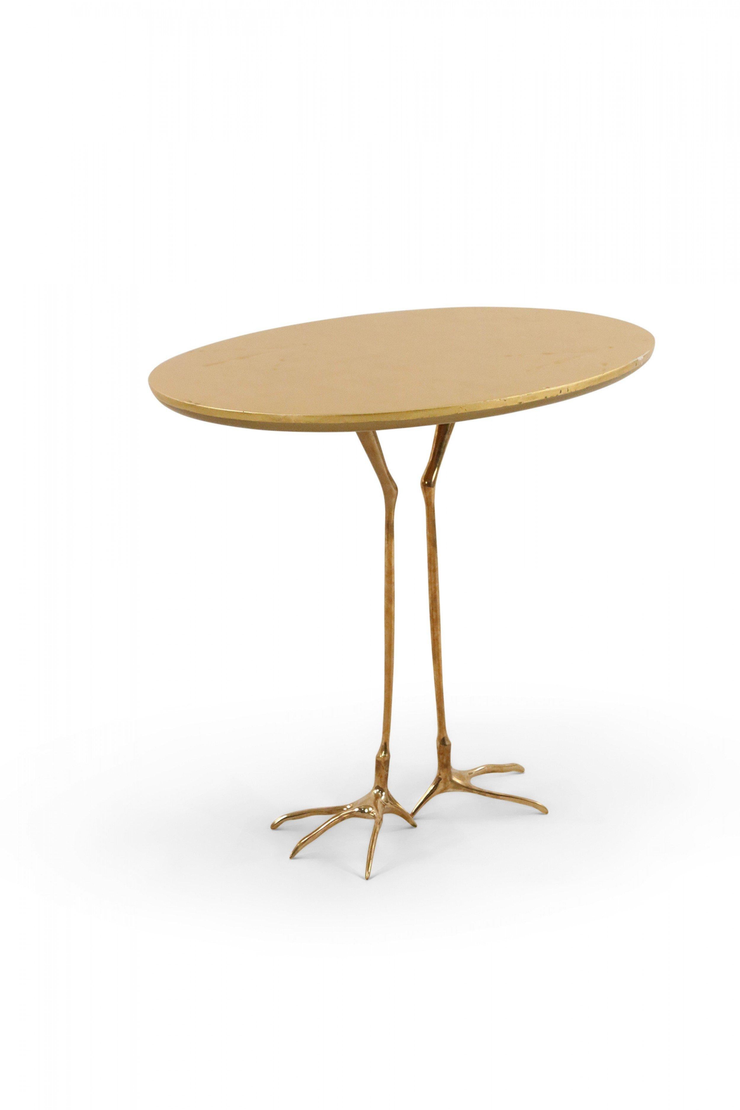 Mid-century gilt metal bird foot end/side table with oval top featuring bird foot-shaped imprints. (MERET OPPENHEIM).
    