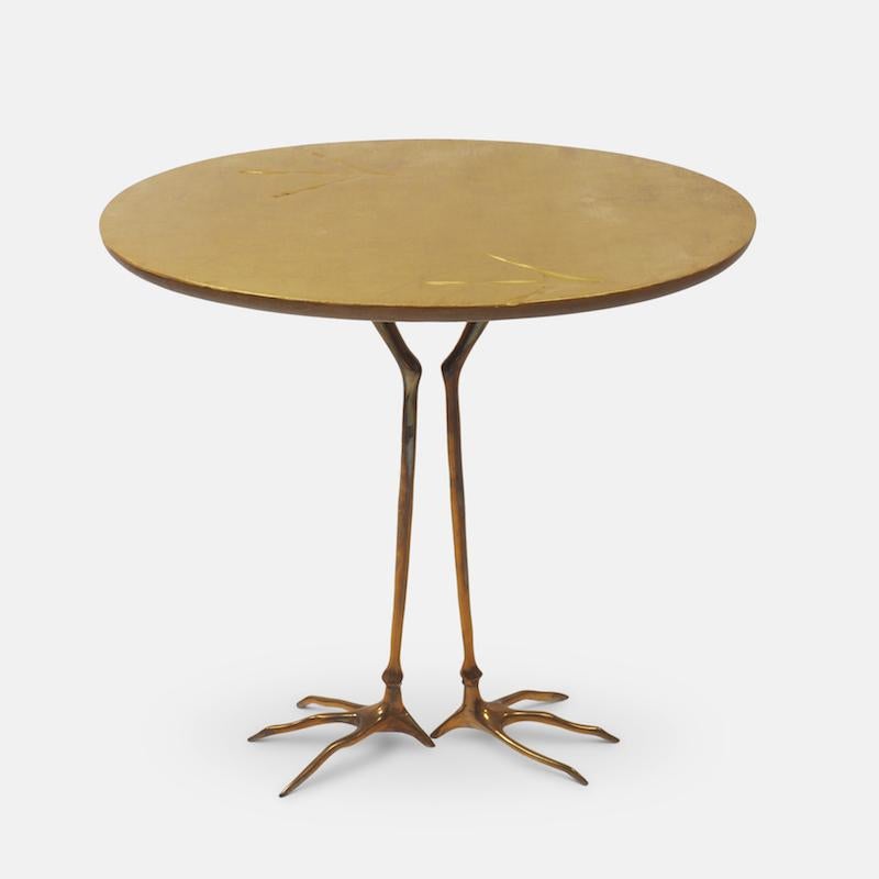 Meret Oppenheim 'Traccia' table produced for Studio Simon's Collezione Ultramobili , Dino Gavina, Milan, circa 1972. 
The tabletop is in gold leaf with the characteristic bird tracks impressed on the surface, the underside is painted with deep