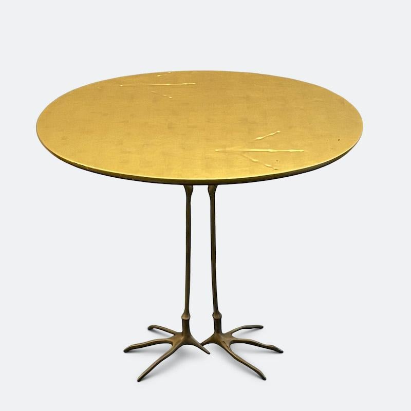 Meret Oppenheim 'Traccia' table produced for Studio Simon's Collezione Ultramobili , Dino Gavina, Milan, circa 1972. 

The tabletop is in gold leaf with the characteristic bird tracks impressed on the surface, the underside is painted with deep