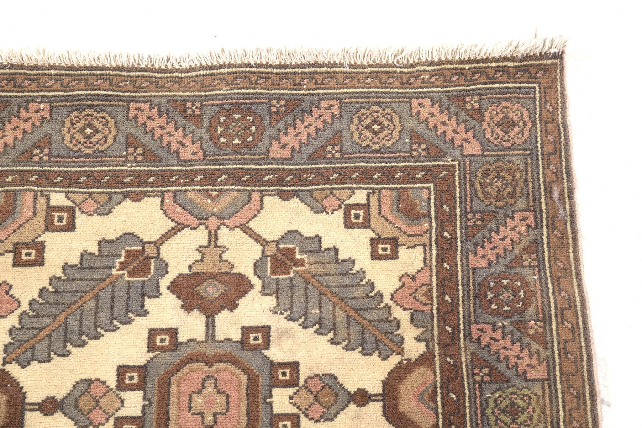 This stunning Lilihan runner features broad flourishes of symmetrical patterns in sage blue, brick red, umber brown, and olive green accents with a cream field. One of the best Persian runners in our store because of its durability can be passed on