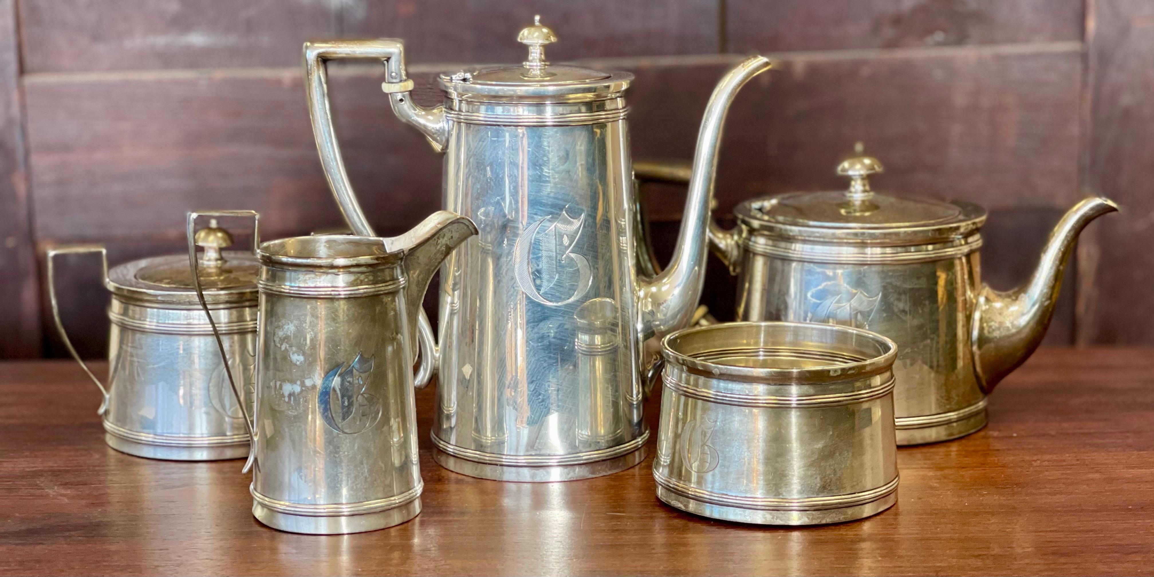 This exquisite tea and coffee set is a rare beauty that will add a touch of elegance to any home. The set is made of high-quality sterling silver (.925) and features an art deco style with a stunning Meriden Britannia pattern. The set consists of