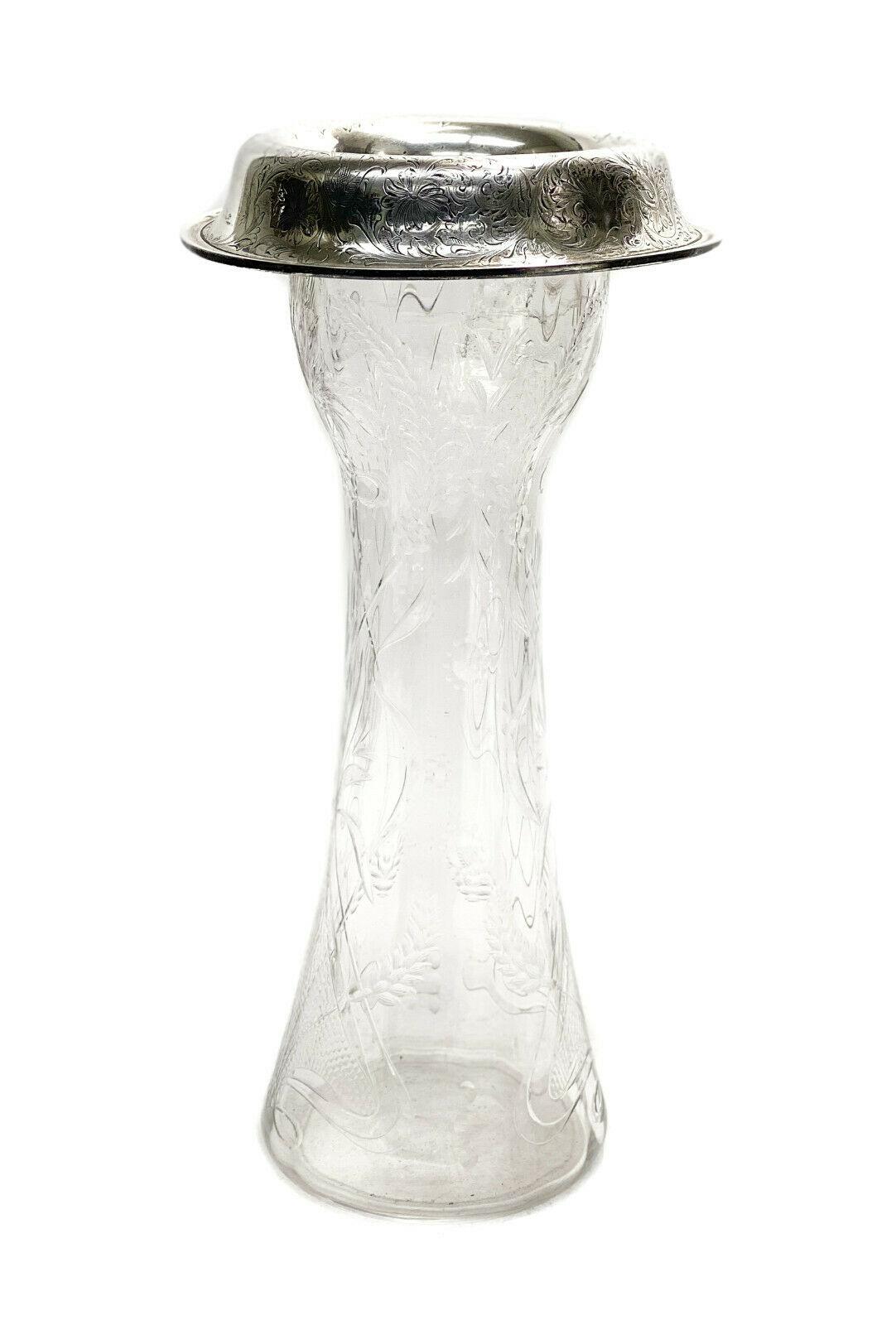 Meriden Britannia Sterling Silver and American Brilliant Cut Glass Vase, c.1900

Etched wheat leaves throughout the exterior of the glass with a polished pontil. The silver rim had had chased foliate scrolls and florals thorughout. Meriden Brittania