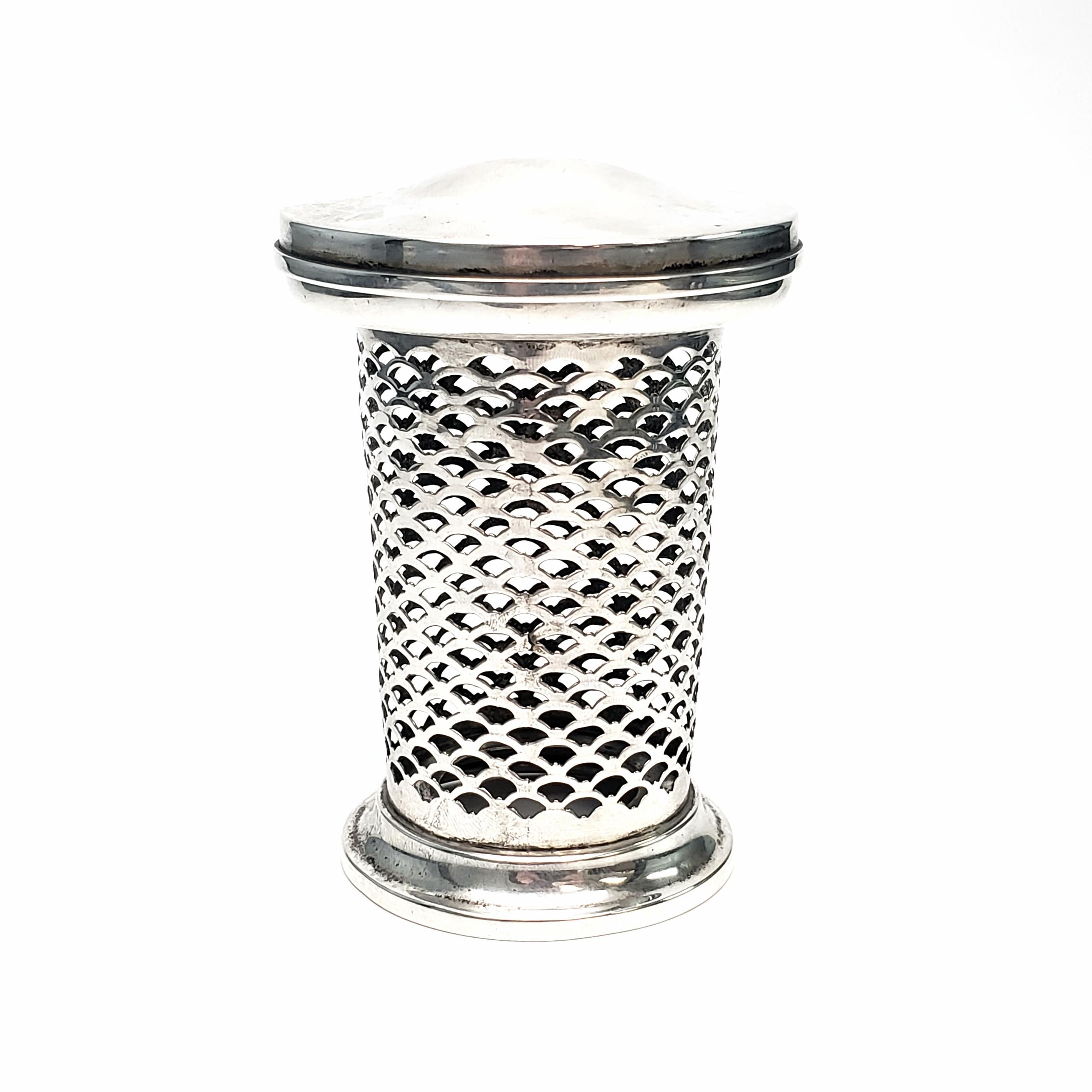 Vintage reticulated sterling silver jar by Meriden Brittania Co of Meriden, CT.

This jar could be a spice jar, a tea caddy or a piece of a vanity set. Features fish scale pierced sterling silver jar and slightly domed lid. Missing glass insert.