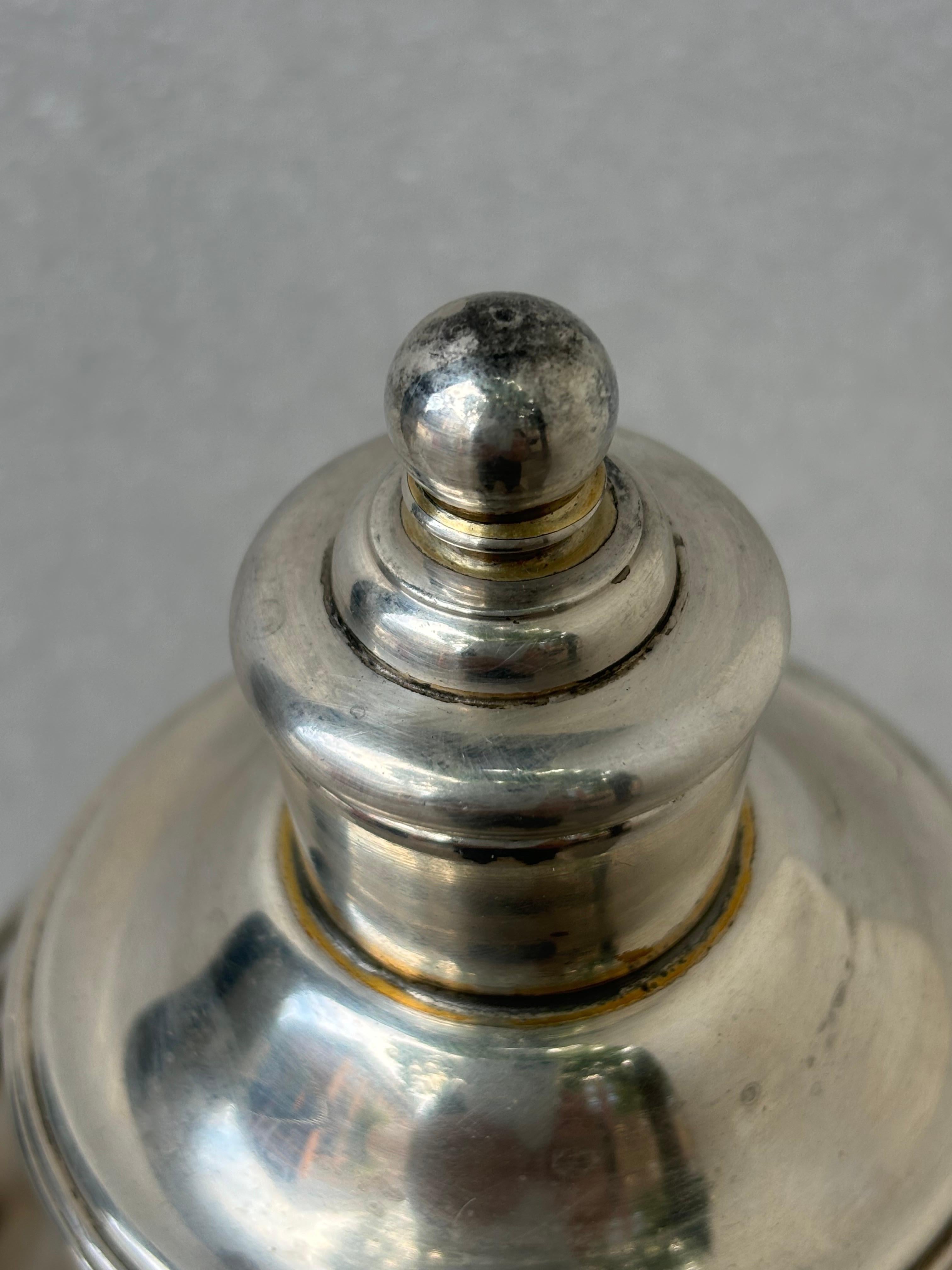 International Silver Co. Meridian Silver-Plate Lighthouse Cocktail Shaker.  Signed and patented 1927.  Nice heavy construction in very nice original condition.  This one might have had a gold wash at some point in it's life.  You can see remnants of