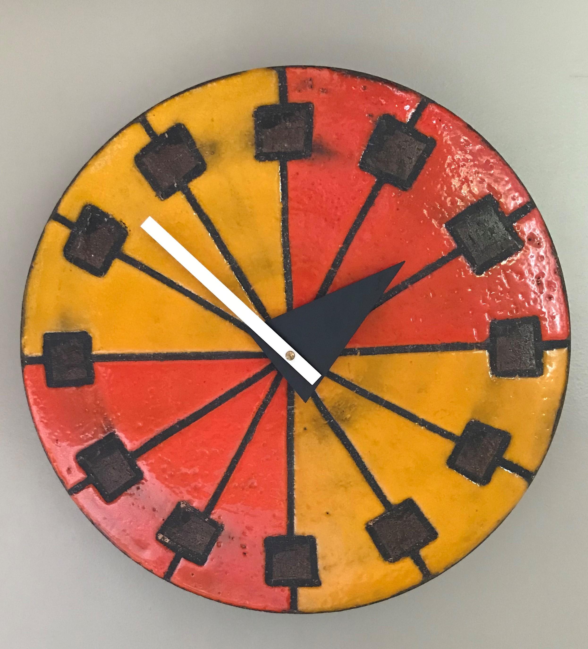 A colorfull Mid-Century Modern Italian ceramic wall clock from the Howard Miller Meridian Collection.  A spoke design with small brown squares at their ends, colored in vivid Orange and Yellow glazes.  The old clock movement was replace with a