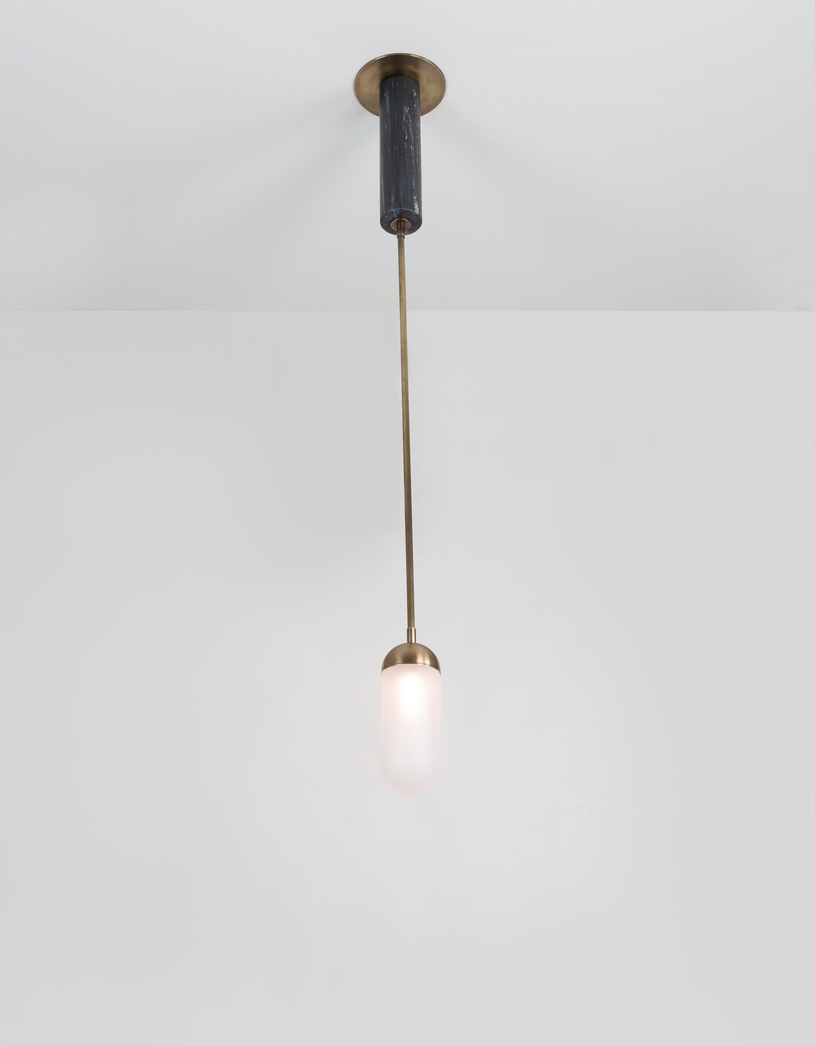Small-scale single pendant by Kalin Asenov. Hand blown glass, marble, antique brass, lacquer finish. The pendant is part of the Meridian series including a ceiling pendant and a sconce listed on 1stDibs.
The specific listing is for a pair of
