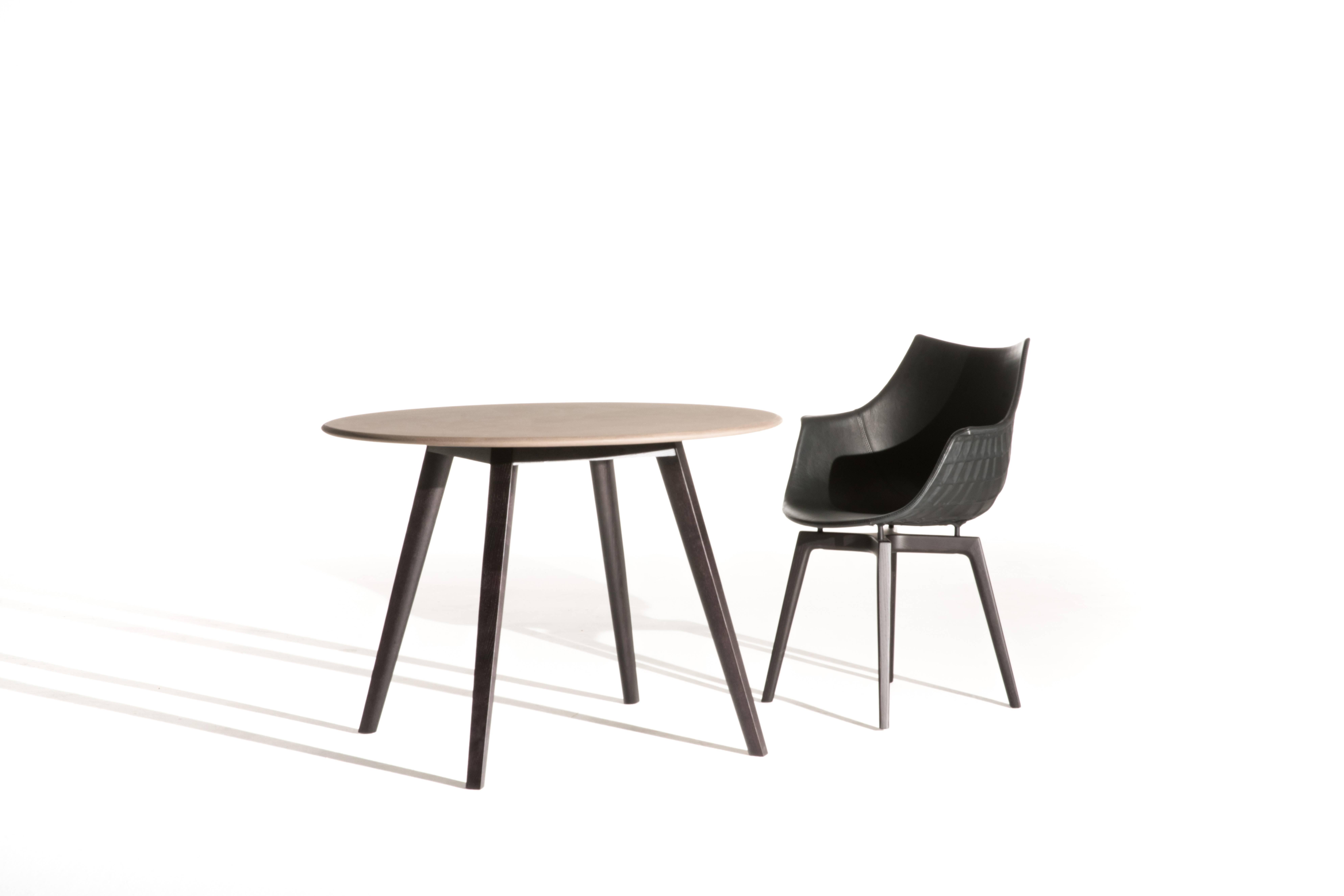 The Meridiana table stems from the ultimate globetrotter chair, revised this year with solid wooden legs. An archetype of the coffee shop or domestic table, it displays a precious balance between the round, wood particleboard top and the solid wood
