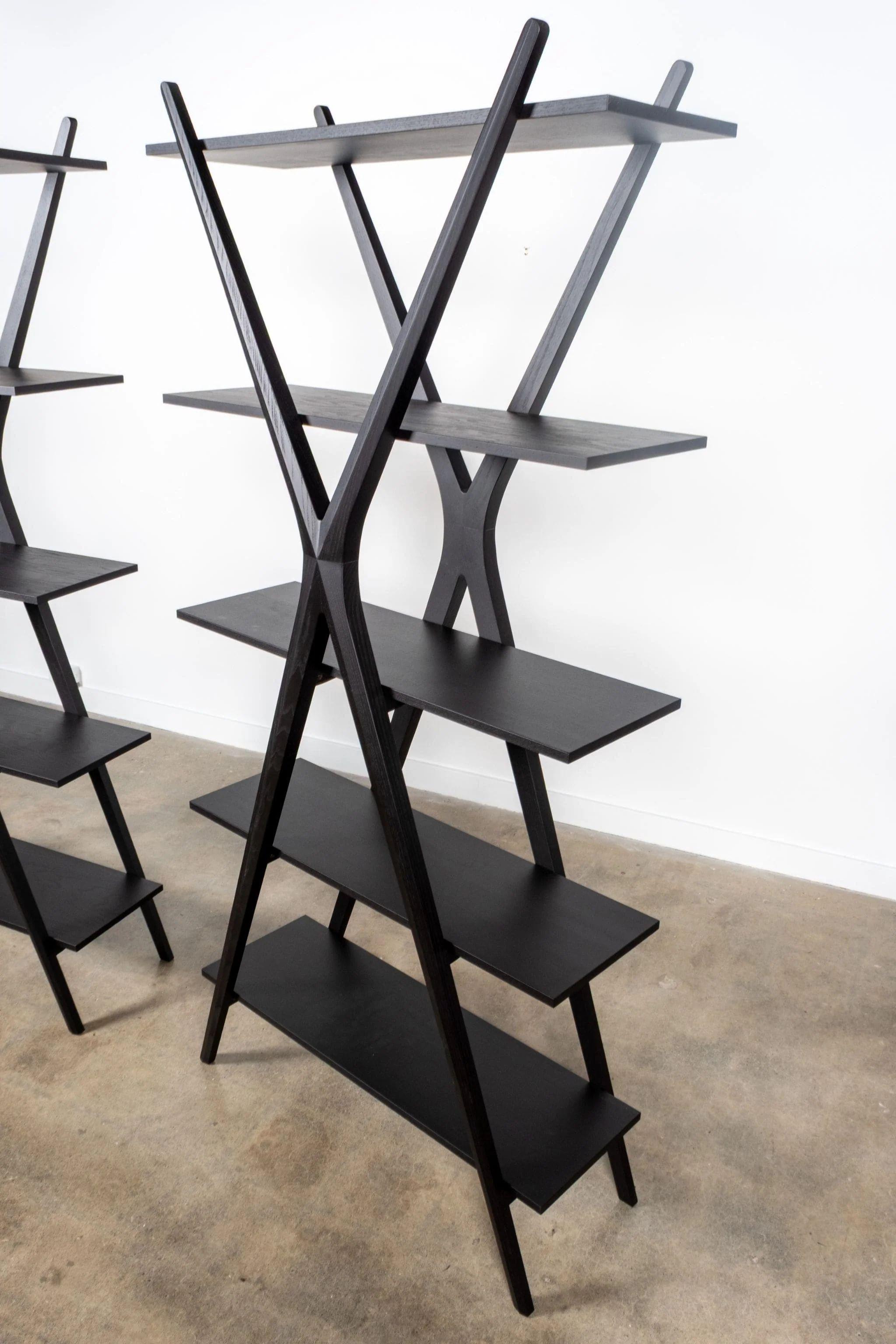 Bookcase in ashwood, supported and structured by the primary design geometry of a diagonal cross.

Current production. Includes Certificate of Authenticity.