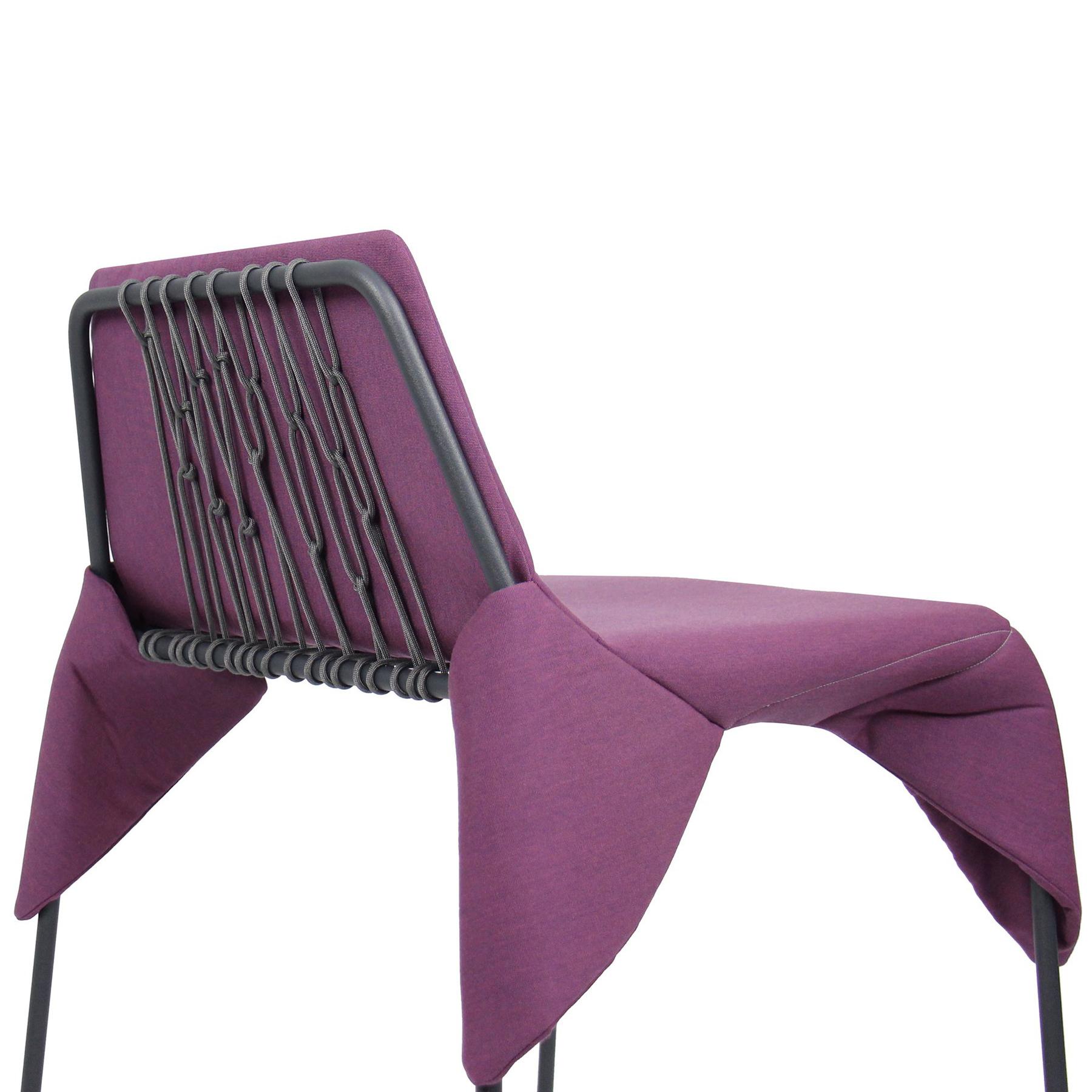 The Merkled Net Wrap Chair features a minimal welded steel frame wrapped with knotted nylon cord and an upholstered removable cushion made from durable outdoor Sunbrella fabric, creating a flexible and comfortable seat. 

Designed and Made in