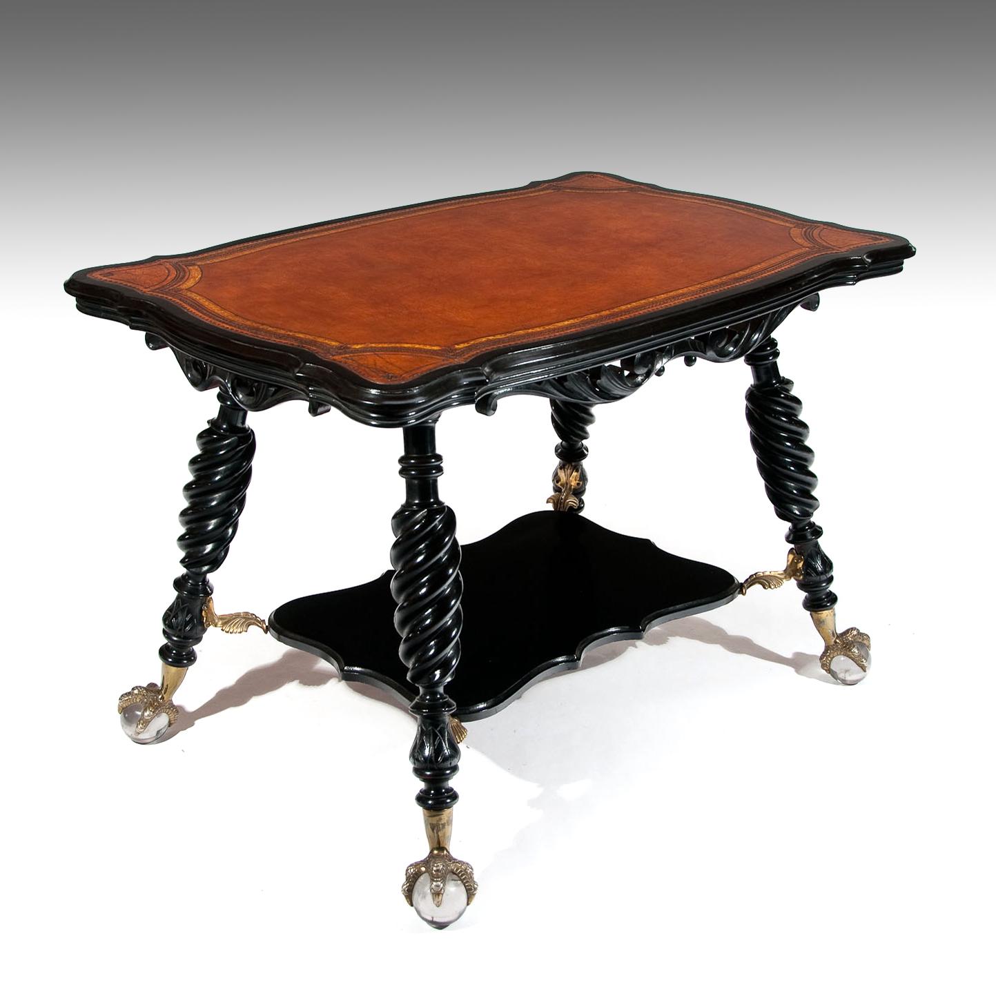 Very good quality antique serpentine shaped and later ebonised leather centre table attributed to Merklen Brothers of America New York.

America, New York, circa 1890.

The shaped top having a later tan leather insert which is gilt and blind