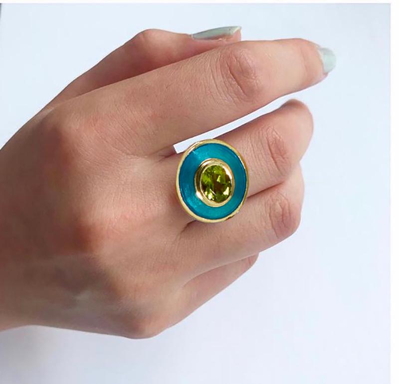 Rooted in clean, classic lines, this bold yet elegant ring reflects the individuality of the wearer. The crisp green Peridot glistens next to the turquoise vitreous hot enamel, transporting us back to a tropical island ocean.   Peridot one of the