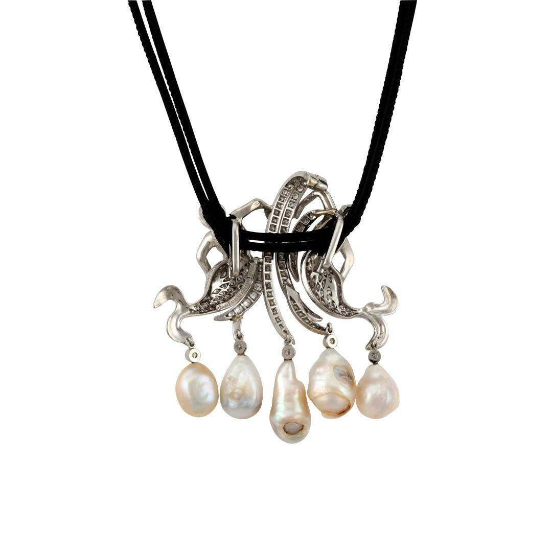 Diamonds and Platinum Mermaid Guardians of the Ming Dynasty Pearls Pendant. 

Two platinum mermaids guard rare four hundred-year-old freshwater pearls recovered from a Ming Dynasty tomb where they had been placed to be used in the afterlife.  The
