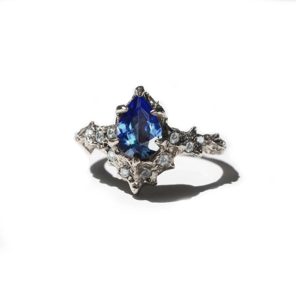 This gorgeous mermaid tanzanite measures 8x6mm and weighs about 1 carat. Small 1.5 mm vs white diamonds are set on the band. This is a wonderful alternative to the classic engagement ring. The blues and greens mesmerize in this color changing stone.