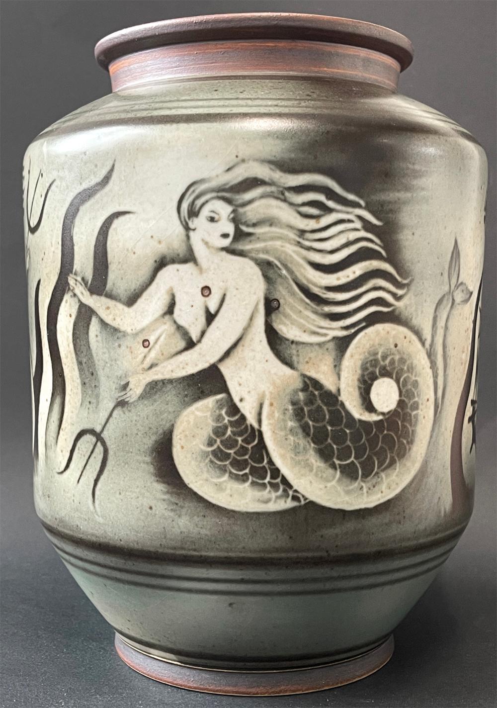 Striking and unique -- we've seen nothing like it before -- this vase or jar by Rorstrand, the famed Swedish porcelain maker, features three Art Deco mermaids cavorting in the sea amidst seaweed and ocean waves, all expressed in a rich, grey-green