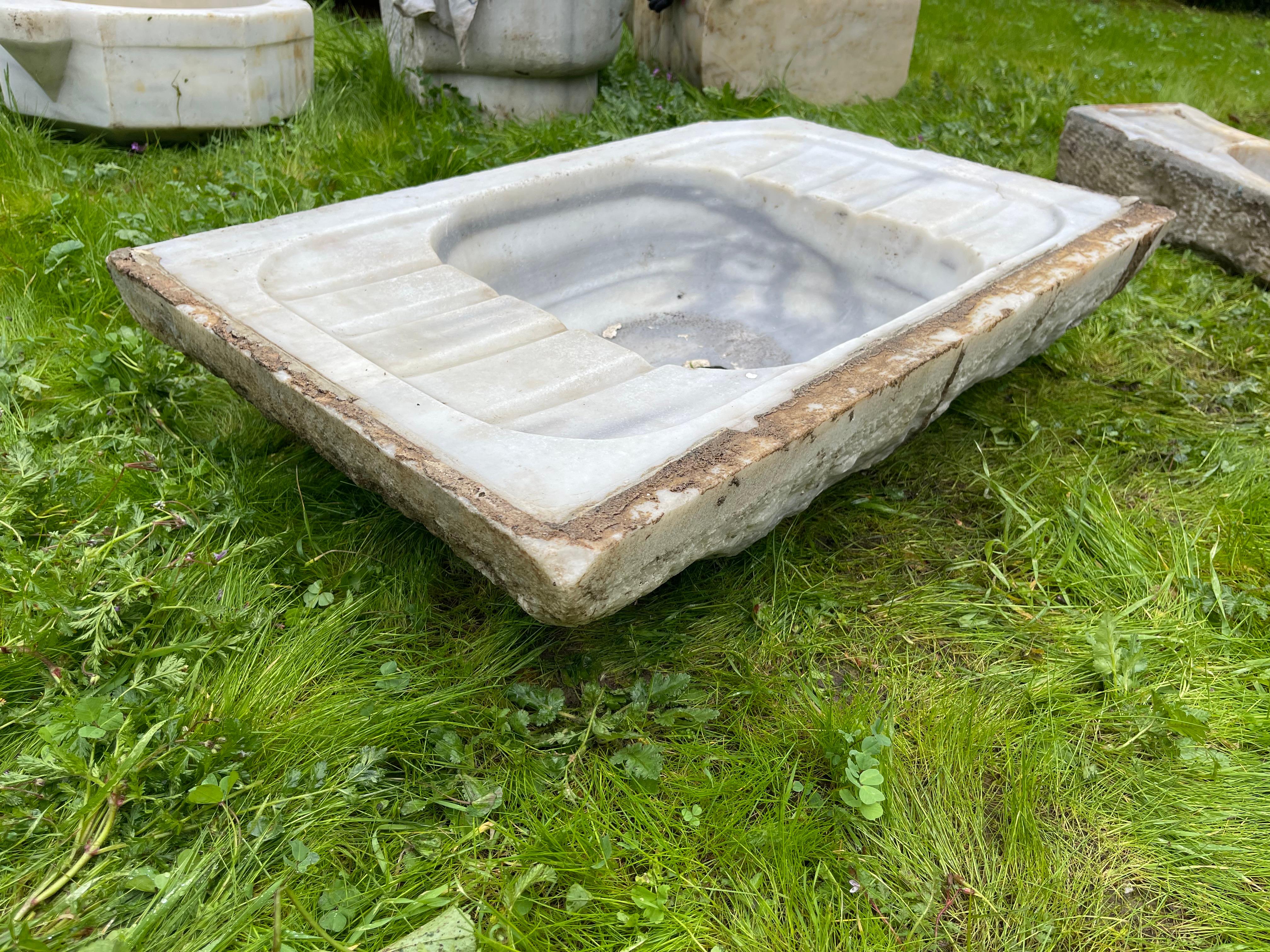 This vintage marble sink features hand-carved details that transport one to the communal bathhouses of the Ottoman Empire, called hamams. This sink features a round basin and shell-shaped walls. 

Hamams are lined with taps, marble sinks, and marble