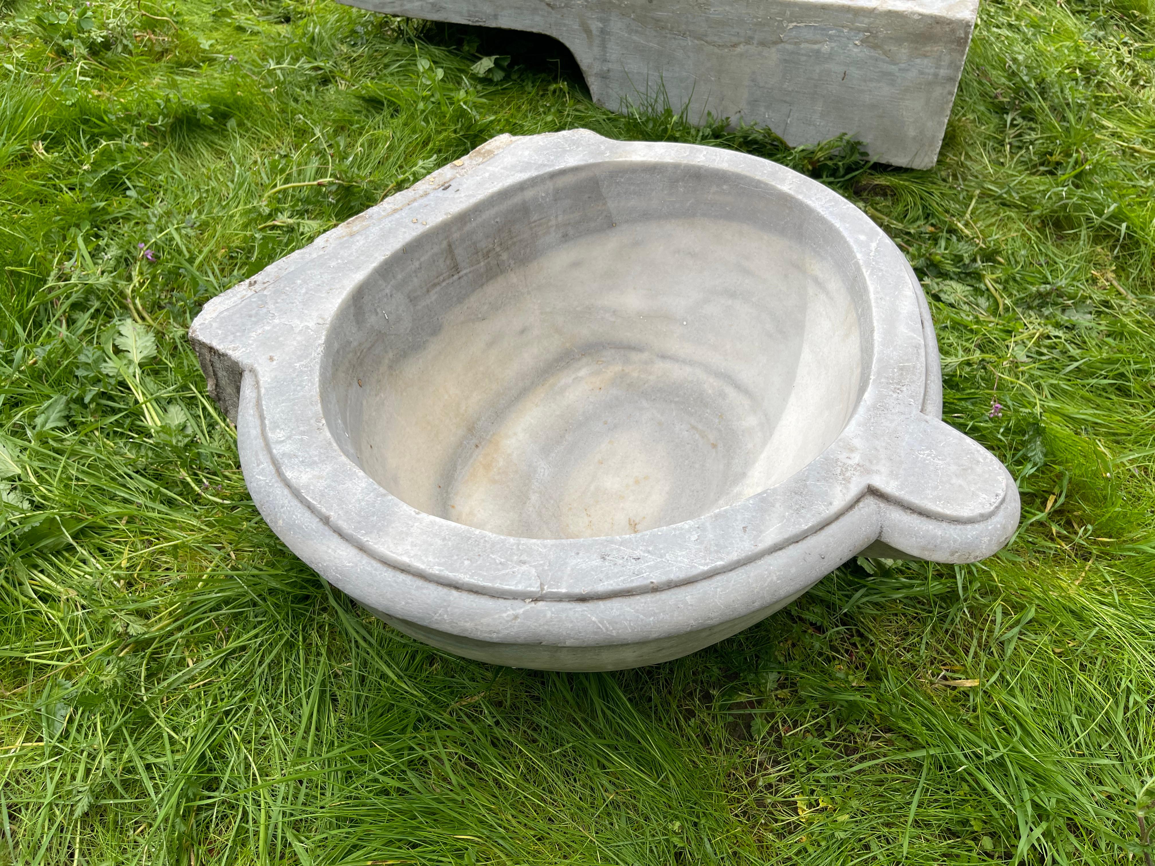 This vintage marble sink features hand-carved details that transport one to the communal bathhouses of the Ottoman Empire, called hamams. This sink features a beautiful round basin and shell-shaped walls. 

Hamams are lined with taps, marble sinks,