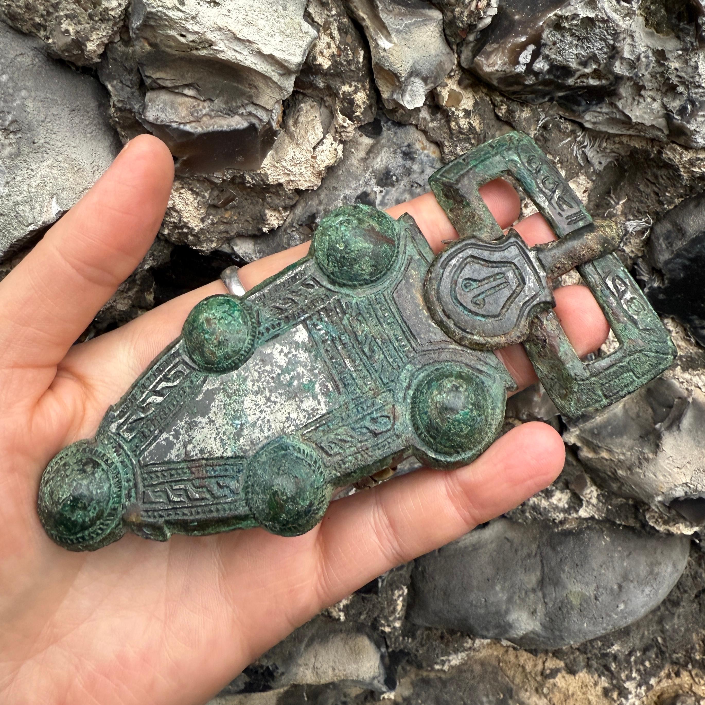 Merovingian Buckle and Trapezoidal Plate with Five Bosses
 
Northern Gaul, circa 600–630 AD
 
Measurements: 13.1 × 6.5 cm.
Material: Cast copper-alloy with tinned “false silver” surface.
 
A large and finely cast Merovingian belt buckle composed of