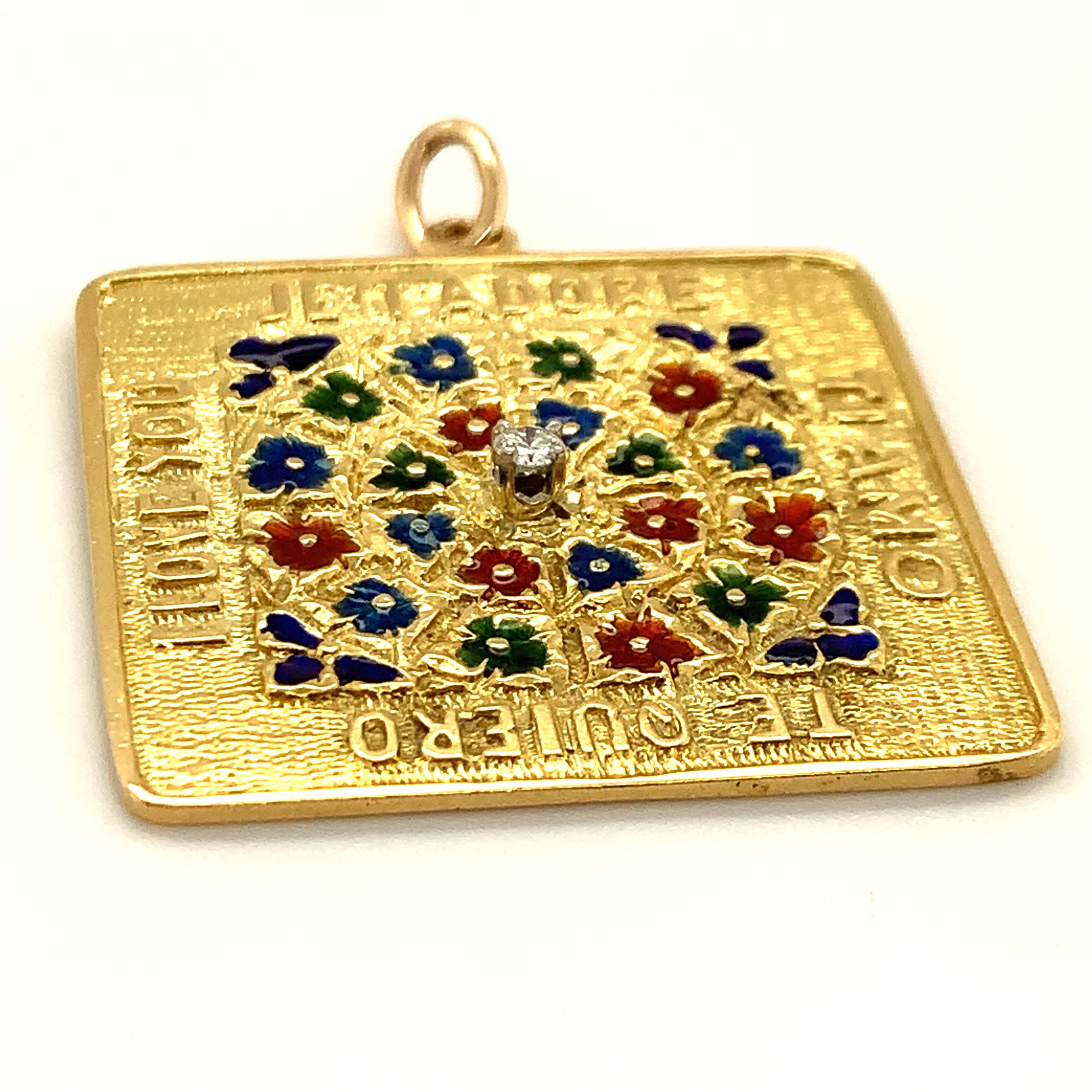 The ultimate love amulet.  A large square charm.  Made and signed by Merrin.  18K yellow gold. The center is comprised of brilliant enameled flowers in a circular pattern.  The colors are  vibrant and reflective; they almost have the effect of a