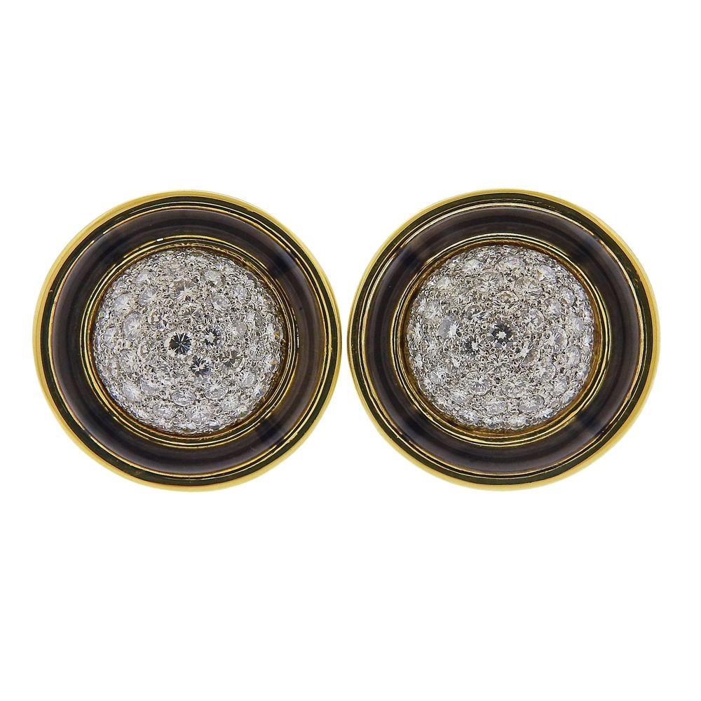 The Merrin Jewelry Company of Madison and Fifth Avenues popularized mail-order jewelry sales in the 1970s.  Presented by the company, a pair of large 18k yellow gold and platinum earrings, decorated with black enamel rim and approx. 6.00ctw. 