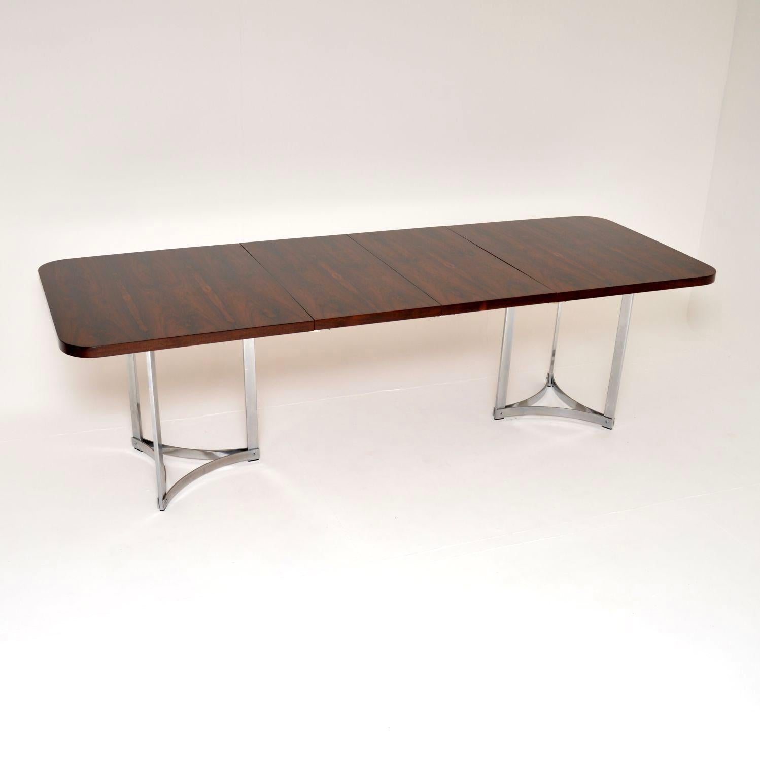 A stunning and extremely rare vintage dining table in wood and chrome, designed by Richard Young for Merrow Associates. This is the least commonly seen model, it has an absolutely beautiful design.

The rectangular top is long and relatively