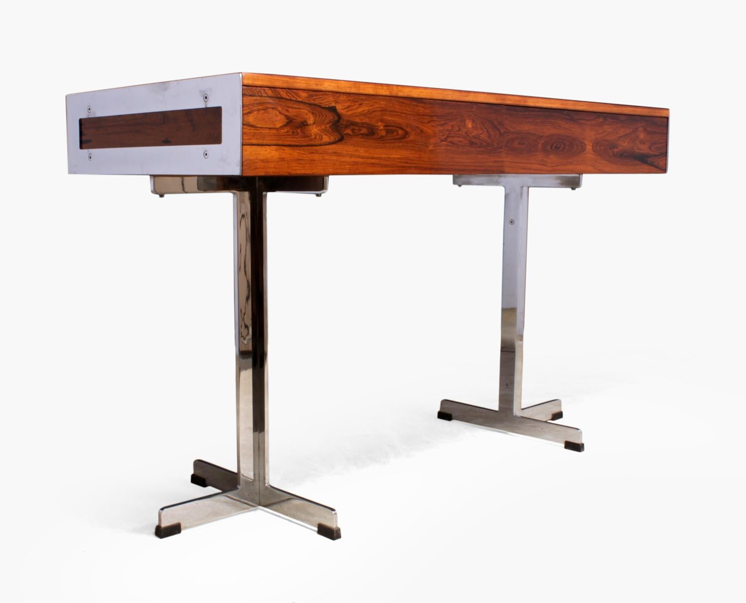 Merrow Associates rosewood desk
Produced and designed in the 1960s by the renowned British company Merrow Associates this very rare two drawer free standing desk, with triple pronged base has been well looked after over the years, the chrome has a