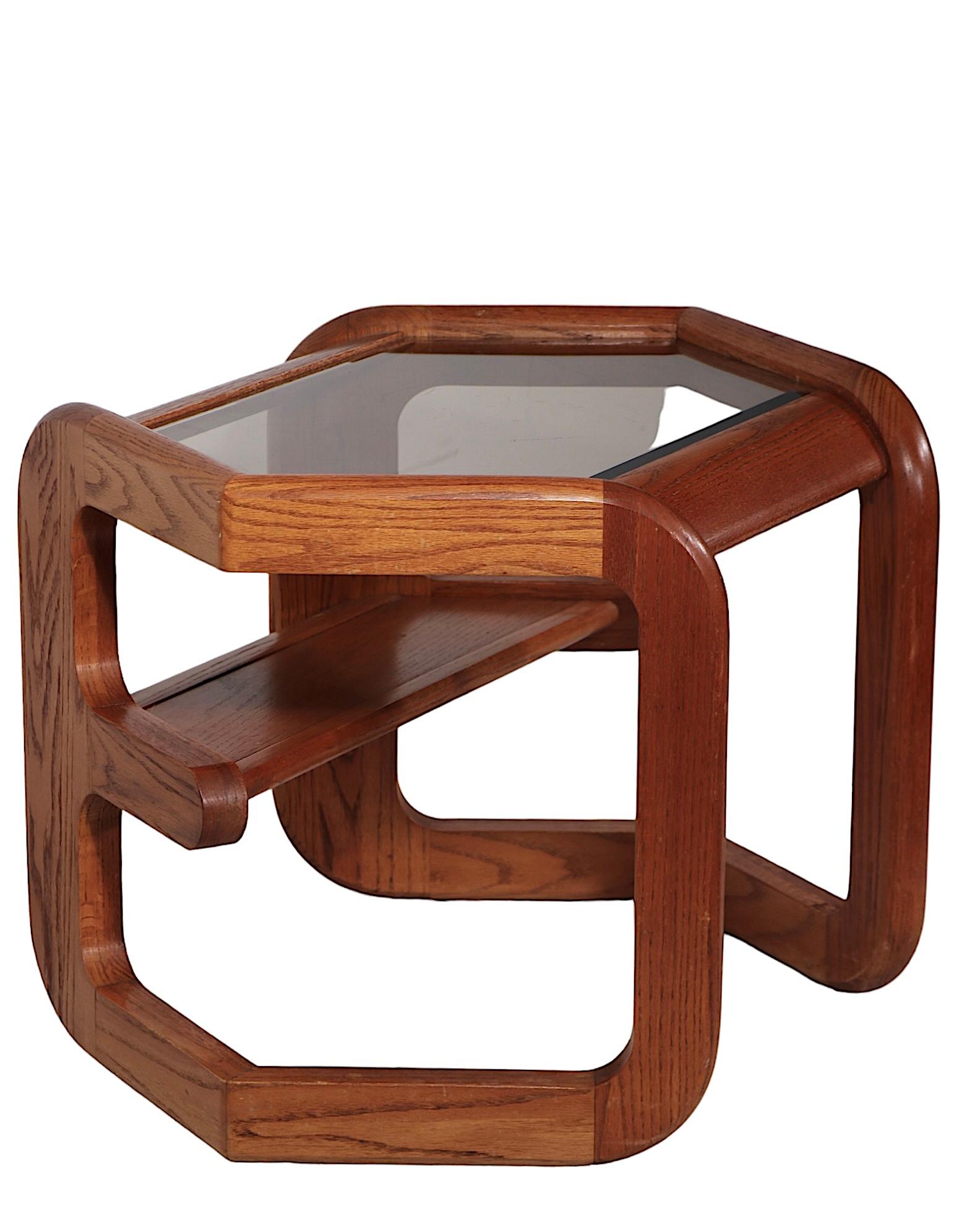 Exceptional post modern side, or end table, designed by Lou Hodges for Mersman, c. 1970's. The table features a sculptural  octagonal solid oak frame, with a bevelled tinted  glass top. This example is in very fine, original, clean and ready to use