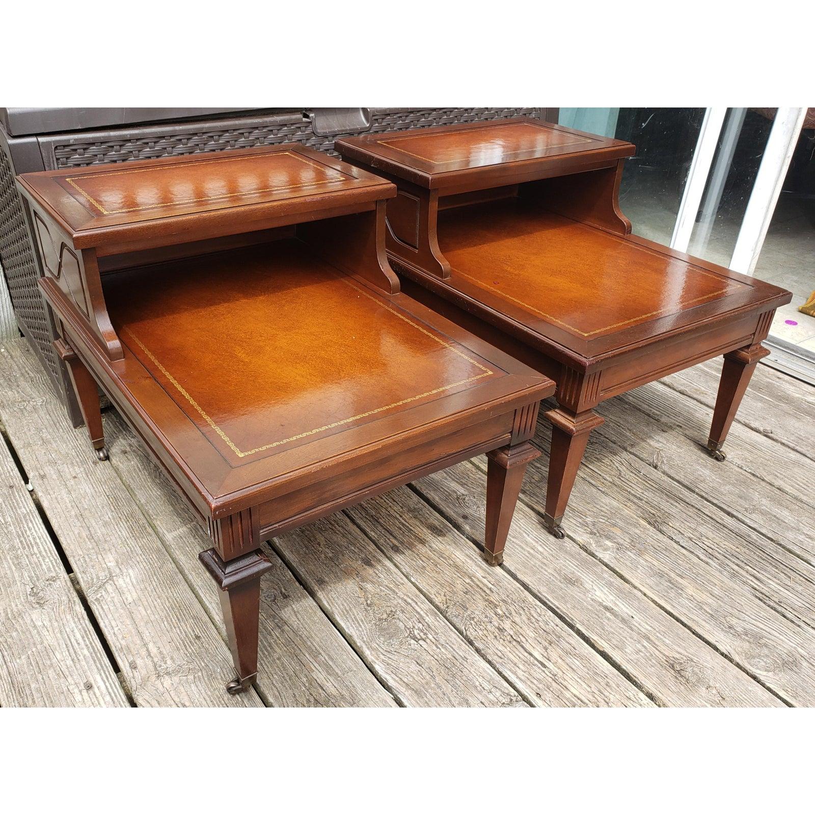 Mersman vintage two tier mahogany with leather top insert. Leather top insert with gold stenciling is in good condition . The two tier tables measures 19.5