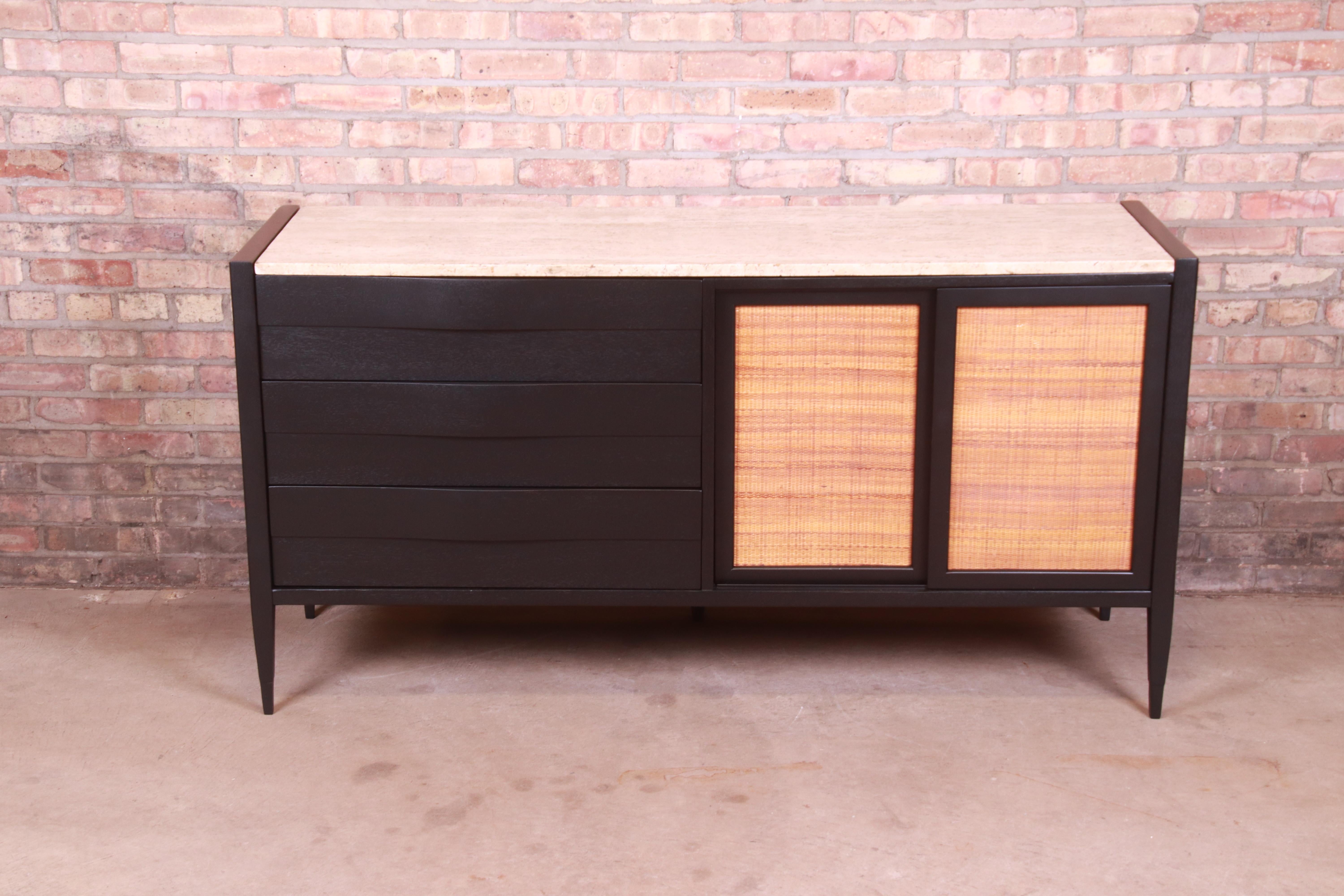 An exceptional Mid-Century Modern dresser or credenza

By Merton Gershun for American of Martinsville

USA, Circa 1950s

Black lacquered mahogany, with unique bow front drawers, sliding cane front doors, and inset Italian travertine