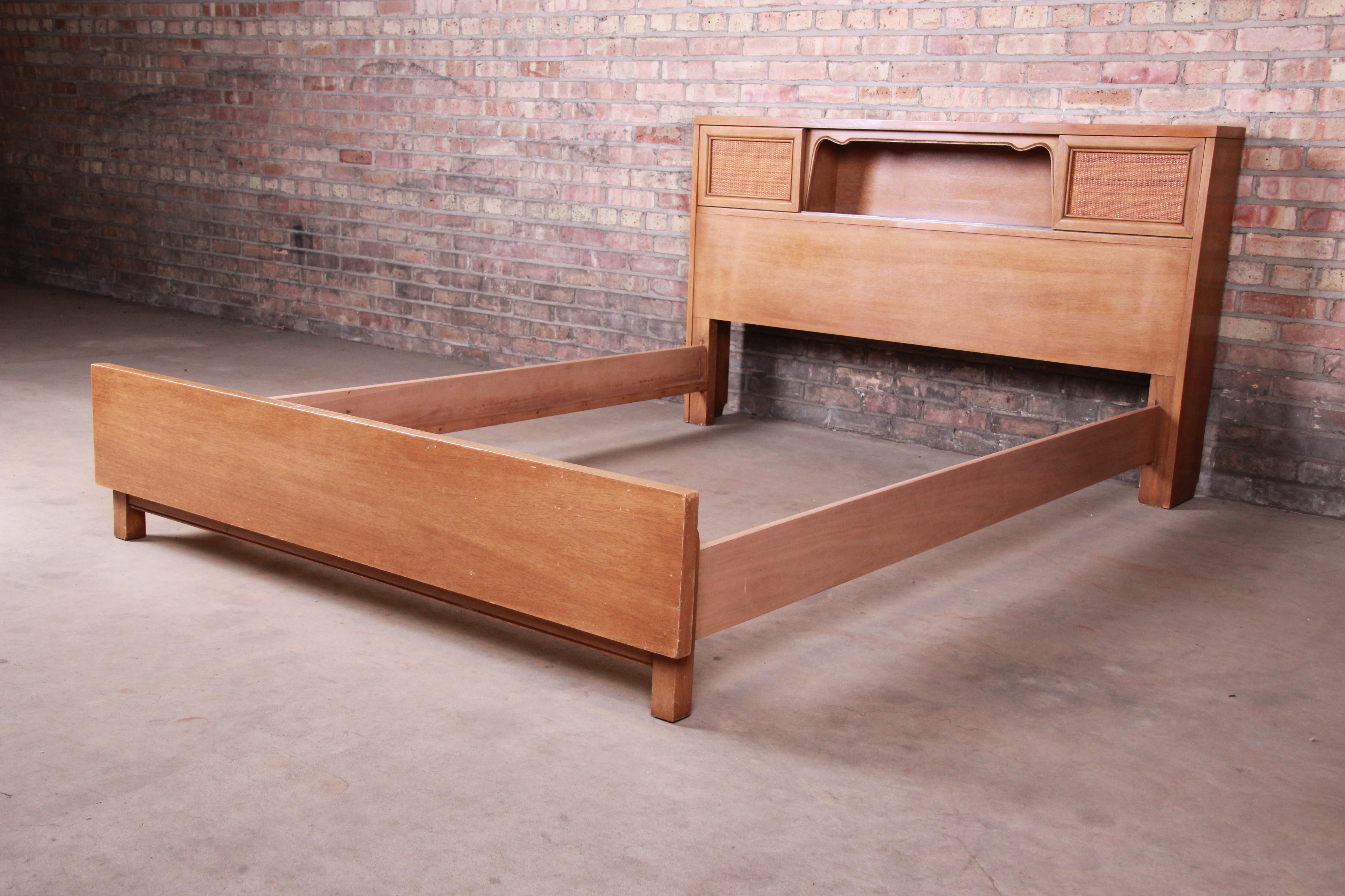 A gorgeous Mid-Century Modern full size bed frame

By Merton Gershun for American of Martinsville,

USA, 1960s

Bleached mahogany, with sliding cane doors on the bookcase headboard.

Measures: 60