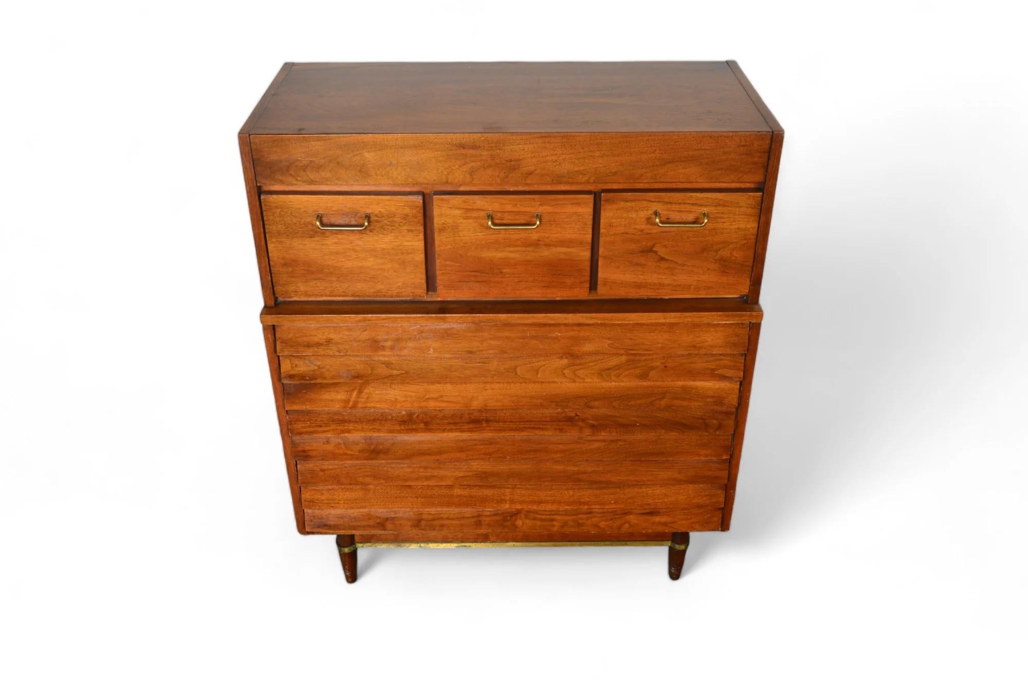 This magnificent highboy dresser was designed by Merton Gershun American of Martinsville in the 1960s for the Dania collection. Crafted in walnut with beautifully patinated brass hardware.

Origin: USA
Designer: Merton Gershun
Manufacturer: American