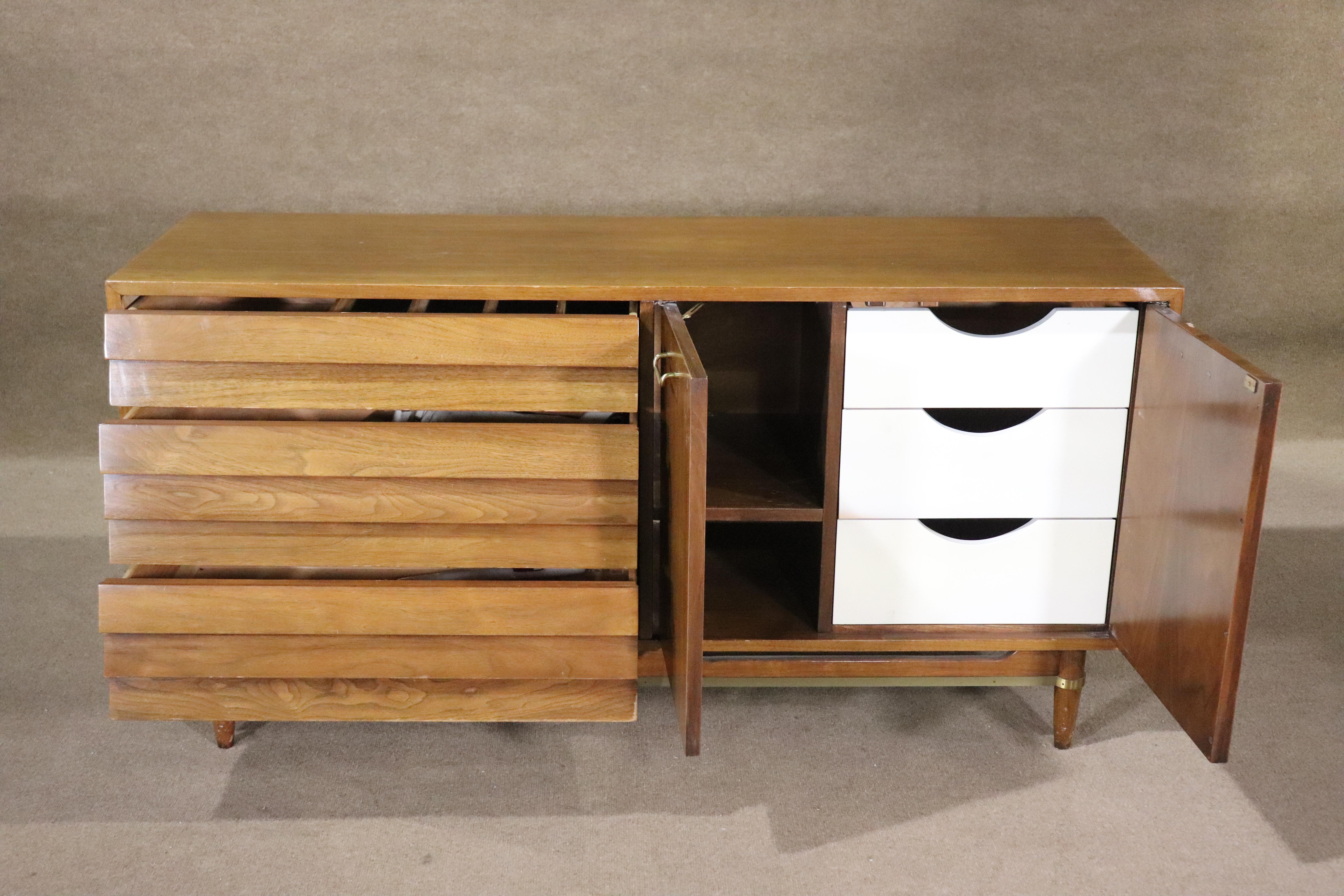 Classic mid-century modern dresser by American of Martinsville, designed by Merton Gershun for his 'Dania' series. Features his louvered front drawers and accenting brass hardware. Right side has cabinet storage and sock drawers.
Please confirm